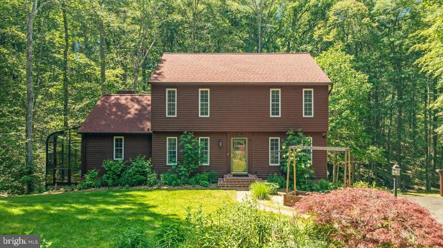 A timeless blend of classic Colonial architecture and custom farmhouse charm, this beautifully updated mini estate offers the perfect balance of refined living and peaceful countryside surroundings. Nestled on more than 2 scenic acres, this exceptional property captures both classic and modern sensibilities with thoughtful upgrades throughout. Enjoy quiet mornings and relaxing evenings from the expansive wraparound rear deck, where towering trees and natural beauty create a private outdoor retreat. Conveniently located just 15 minutes from the VRE Manassas Station, commuting to Washington, DC becomes a smooth and relaxing ride while allowing you to enjoy the tranquility of country living every day. This is the rare opportunity to work in the city and live surrounded by nature and serenity. <br><br>

An elegant brick walkway welcomes you to the front entrance, where a gracious foyer opens to formal living and dining rooms filled with warmth and character. Pine hardwood flooring flows through most of the main level, complemented by stylish new light fixtures that brighten every space. The spacious kitchen and breakfast area overlook the scenic rear grounds and showcase stunning brand-new Calacatta Quartz countertops paired beautifully with stainless steel appliances. The dramatic family room is a true showpiece with soaring cathedral ceilings, rich wood paneling, walls of windows, and a charming free-standing gas stove. Step directly onto the multi-level deck and seamlessly blend indoor and outdoor living. Upstairs, engineered wood flooring enhances the level featuring three spacious bedrooms, including an inviting primary suite with a beautifully updated spa-inspired bath complete with a soaking tub, frameless glass shower, quartz countertops, updated mirrors, and modern lighting. The secondary bath has also been tastefully renovated with elegant finishes. <br><br>

The finished lower level offers incredible versatility with an additional bedroom, full bath, recreation room, and another free-standing gas stove that adds warmth and ambiance. A stunning solarium surrounded by glass panels creates a breathtaking space to enjoy panoramic outdoor views year-round while offering direct access to the rear deck. Major improvements over the years include a new roof, newer attic insulation, HVAC system, updated appliances including washer and dryer, fresh paint, and a newly installed radon remediation system. Outside, carefully designed landscaping and native gardens have been lovingly maintained to keep the property flourishing in every season. Even more extraordinary, this property is a certified Wildlife Sanctuary where efforts to restore natural habitat and biodiversity have created a haven for more than 10 tracked sanctuary species. <br><br>

Beyond the property itself, the location offers endless recreation, dining, shopping, and entertainment opportunities nearby in historic Old Town Manassas. Nature enthusiasts will appreciate the close proximity to Prince William Forest Park and its 15,000 acres of woodlands, streams, and scenic trails. In today’s fast-paced world, it is increasingly rare to discover a place where timeless beauty, peaceful surroundings, and modern comforts come together so effortlessly. Here, life slows down, nature takes center stage, and home becomes a true retreat from the everyday.