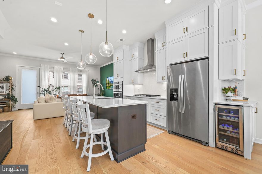 Welcome Home! This stunning 4 level, 2 car garage townhouse situated on ideal lot overlooking open space and common area. Located in sought after Chantilly's Commonwealth Place at Westfields, this Toll Brothers home is a must see.   Inside features many beautiful architectural and design upgrades. The entry level features a cozy bedroom and full bath—perfect for guests, a private office, or even a rec space. Upstairs, the main level is bright, open, and filled with natural light. The gourmet kitchen is truly the heart of the home, with upgraded cabinetry and countertops, a custom backsplash, high-end appliances, stylish lighting, and even a wine fridge with additional custom cabinetry. The large family and dining room spaces boast floor to ceiling windows. Third floor includes two large suites each with their own en suite luxury bath and walk in closets. The top-level loft  provides private space for a family room, office, or 4th bedroom— with a half bath, and access to a stunning rooftop terrace that offers beautiful views and privacy and includes gas and water connections. Located just steps from the shopping center:  Wegmans, Cava, Lazy Dog, and minutes to Rt. 28, Rt. 66, Rt. 50, Dulles Toll Road, and Dulles Airport, this home offers the perfect mix of modern style, smart living and unbeatable convenience!