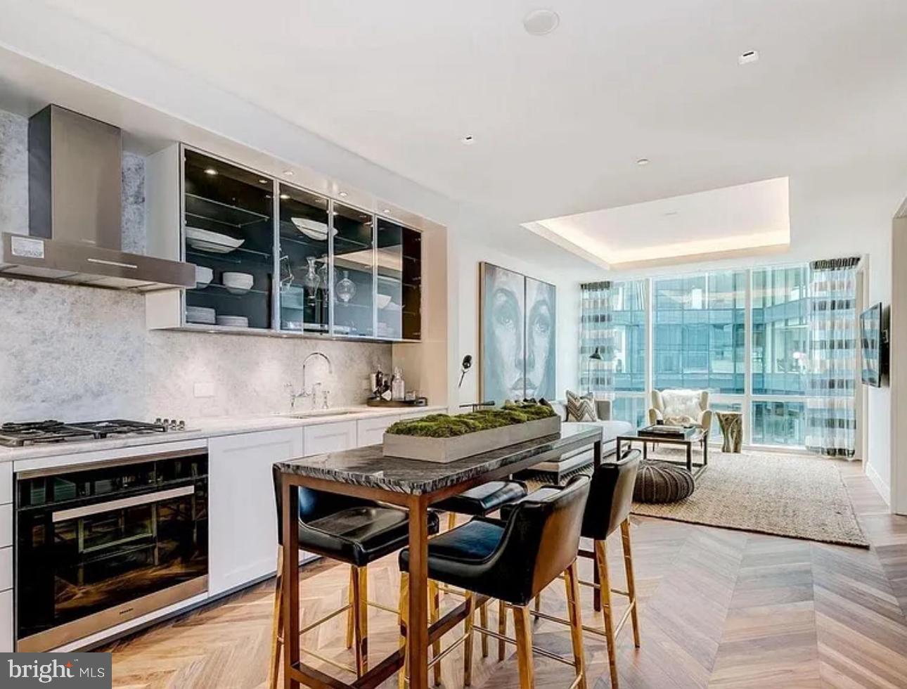 Experience breathtaking Inner Harbor views from the most prestigious address in Baltimore’s coveted Harbor East neighborhood — the Four Seasons Private Residences. Located on the 19th floor, this stunning fully furnished 1-bedroom, 1.5-bathroom residence offers over 1,100 square feet of refined living space. An open-concept layout is beautifully complemented by striking chevron-patterned walnut hardwood floors and expansive floor-to-ceiling windows that flood every room with natural light and panoramic water vistas.
The custom-designed gourmet kitchen is a culinary showpiece, featuring top-of-the-line Miele appliances and a sophisticated waterfall-edge marble island that flows seamlessly into the spacious living area. The serene primary suite includes a generous dressing area and a spa-inspired marble bathroom with a walk-in shower and a freestanding soaking tub.
As a resident, you’ll enjoy exclusive access to the 28th-floor amenity level — a private retreat featuring an indoor, heated saltwater infinity pool with a rooftop sundeck, a sauna with harbor views, a state-of-the-art fitness center, and elegant indoor and outdoor entertaining spaces. Amenities also include a dining and lounge area, conference room, billiards area, kitchen, outdoor fireplaces, grilling stations, and even an AstroTurf dog-walking area.
The Four Seasons Private Residences Baltimore offers the ultimate in luxury living — blending sophisticated design, world-class amenities, and the unmatched service of a globally renowned hotel brand.