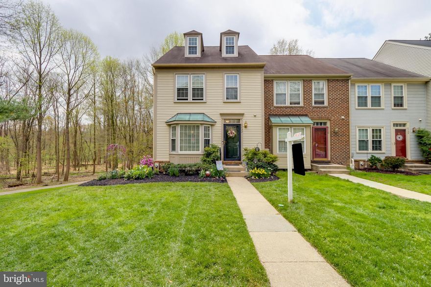 Experience your very own HAVEN in the Dorsey Hall neighborhood of Ellicott City! Before you reach the steps leading to the front door, you can not help but notice the beautiful landscaping that just captures your undivided attention. This 4 level, 2200 sq.ft. 3 bdrm, 3.5 bath, END UNIT townhome with loft and walkout basement is a WINNER! As soon as you open the door, you can not help but notice the gleaming hardwood floors throughout the main level.  The eat-in kitchen receives an abundance of natural light and has a lovely bay window with wood blinds, pantry closet with ample shelf space, lots of cabinets, and ceramic tile floor. The dining room has large windows and plenty of space for family/friends to enjoy a grand holiday event. The sunken living/family room has 8.5' ceilings and slider door that leads you to the 2 tiered Trex deck which backs to the woods and a walking path.  The fully finished basement has a full bath, lots of storage space in the utility room,  washer/dryer, a pellet stove, wet bar, walkout to the patio, and if you need office space and a large enough space to create recreation room, additional family room or workout area or what ever adds to your happiness.  As you journey up to the bedroom level, and enter the Owners suite, you will appreciate the vaulted ceilings, skylights, 3 full size closets (2 of the closets have the ELFA shelf system) and the space available for additional furniture . The Owner's bath has a great  soaking tub for those days when you just want to decompress and create your very own spa.  Some special features this lovely home has are: ADT alarm system, ceiling fans in all bedrooms, storage in dormers, all 4 bathrooms updated, hardwood stairs and 2nd floor hall, new slider, great quality Corian countertop with integrated sink and hot water tap, newer HVAC with humidifier, newer water, built in closets in the loft and the roof is in stellar condition according to the licensed roofer who gave owners a roof certification.  The neighborhood hot spots are within walking distance! For those that like or love the outdoors,  the Dorsey pool with hot tub and kiddie pool is a hit.  The Fairway Hills golf course is right across Rt. 108 (5 min drive, 10-15 min walk), Centennial Park/lake is within walking distance and the Dorsey Search Village Center has the Giant supermarket, Parcel Plus, Shell Gas station, restaurants, cleaners, and so much more!