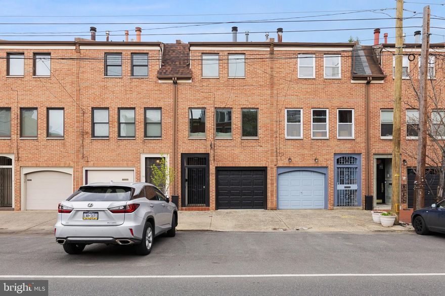 A true unicorn of a rental property, rare to see even more rare to experience!
This city oasis is nestled in the heart of Bella Vista and offers the best of the most convenient city lifestyle. The first floor features a lovely entry foyer with access to the built-in garage which offers secure parking inside as well as an additional spot in front for a total of 2 CAR PARKING INCLUDED! To the back there is a utility room with a full-size washer and dryer, and space for a workout room/art studio/storage. Just up the stairs you’ll enter the large chef’s kitchen complete with Wolf range and full stainless steel appliance package, expansive granite counters, glass tile backsplash and enviable cabinet space. The sunny east facing window and sliding door lead out to the back patio where you can grill and dine al fresco in peace and privacy. Heading up to the next level there is a wide-open living space with gorgeous blonde maple flooring, a working wood burning fireplace, and large windows looking west over 11th street. The next level up features a full bathroom with a large soaking tub, and a generously sized bedroom with a full-size closet. Continuing up, the primary suite has its own level complete with a luxurious bathroom with a fully tiled rain shower, large sunny windows and a whole wall banked with closet space. Just up the stairs you’ll be drawn to the fabulous deck, which even has a landing nook that perfectly houses a work-from-home desk situation so perfectly you can take calls outside in the sunshine and dare to call it work. This home screams quiet elegance from it’s perfect finishes to it’s sunny light-filled spaces.  It’s impeccably located within walking distance to Whole Foods, CVS, Segar park, The 9th Street market, and loads of fantastic restaurants and boutiques. You could also have a very pleasant commute to Center City by foot or by several means of transport. Owner prefers no pets.  Do not sleep on this treasure of a home!