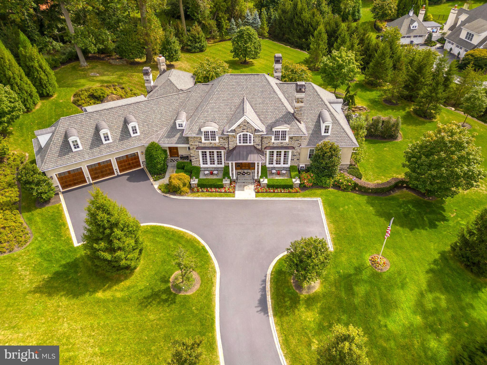 Welcome to 314 Winfield Road, an extraordinary custom showstopper built by the amazing C.F. Holloway that will please even the most discerning buyer. Nestled on 2.34 acres of lush grounds in the highly ranked Tredyffrin-Easttown School District, this home offers over 8200 square feet of pristine living space created with entertainment in mind. The stone facade, front gardens, and patios greet you before entering into the 2 story Foyer with marble floor & crown molding. Continue to the formal Dining Room featuring hardwood floors, exquisite light fixtures, glass display wall for your art pieces, as well as an adjoining butler's pantry, making this the perfect setting to host formal dinner parties. The Living Room with dramatic tray ceilings, light fixtures, and gas fireplace, as well as an adjoining bar area w/wine fridge, and access to the gorgeous slate patio, create an ideal entertainment space with plenty of room to gather with family and friends. The eat-in gourmet Kitchen boasts Wood-Mode custom floor to ceiling cabinets, granite countertops, tile backsplash, and top of the line appliances including wall oven & convection ovens, & Wolf steam microwave oven, 6-burner gas stove & Wolf induction cooktop, Zephyr range hood, 2 sub-zero refrigerators, 2 dishwashers (one in butler’s pantry), center island, built-in desk space, and adjoining Den w/ gas fireplace & patio access. Make your way to the incredible main floor Primary Suite with 2 Bathrooms, 2 walk-in closets/dressing rooms, marble shower, and soaking tub. Tray ceiling w/recessed lighting & chandelier, plenty of natural light, gas fireplace, and patio access make this space the perfect place to start and end your days. An Office with built-ins & fireplace, laundry room, and another Half Bath complete the first level. Take the elevator upstairs to find 3 additional Bedrooms, all with their own Full Bathroom, and a secret fully ventilated cigar room with hidden access through one of the bedroom closets. Head down to the impressive lower level, designed with entertaining in mind, to find a wine cellar, two bars, den/media room, game area w/pool table & shuffleboard, exercise room, full kitchen, half bath, and outside access to a second slate patio. The back yard with multiple outdoor spaces including a soaking pool/hot tub, outdoor shower, and garden, is your own private oasis to enjoy. With 8 fireplaces, full surround sound system both inside & out, and stylish touches throughout, no detail has been overlooked. Superb location with easy access to major highways, public transportation, shopping, and all that Devon has to offer, this stunning home is a must see! April 18 Open House Cancelled