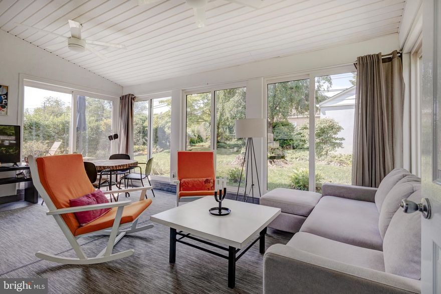 Tucked away in the tranquil neighborhood of Andorra and steps from the Wissahickon forest, is 8716 Wissahickon - a light-filled, sleek 4-bedroom, 2.5-bathroom single-family home with a European vibe. Upon entering, you're greeted by a charming sunroom that opens up to a spacious living room with beautiful hardwood floors. The open-concept design seamlessly integrates the living areas, creating an inviting space for relaxation and entertainment. A renovated eat-in kitchen boasts white cabinetry, wood countertops, and a farmhouse sink. The true highlight of this home is the stunning sunroom, with floor-to-ceiling windows, sliding doors, and an electric fireplace. This sunroom offers a fantastic view of the large, landscaped backyard, complete with a Trex patio, sculptural fountain, and raised garden beds. It's an ideal space for entertaining, playing, and gardening. Off of the sunroom is a unique powder room equipped with a showerhead. Constructed with waterproof materials, this versatile room is perfect for dog washing and can handle splashes without any worry. This could also make it possible to convert the room to a main floor bedroom suite, if needed. A short flight of stairs leads to two spacious bedrooms, one currently used as an office, and a renovated bathroom with tub/shower. Both bedrooms feature huge double closets, providing ample storage space. A few steps further up, you'll find an optional fourth bedroom, office, exercise room, or playroom. The fourth floor would make a perfect primary suite with its own newer full bathroom with a shower. The unfinished basement, with its high ceilings, offers great potential for storage, a workout space or a game of ping pong. No parking worries with a one-car detached garage. Recent upgrades include a brand-new roof installed in June 2024, complete with a 10-year transferable warranty, and new windows on the second and third floors. This home's location is unparalleled; just a three-minute walk to Wissahickon Park, the Houston Playground/Recreation Center, and the Courtesy Stables. A seven-minute drive takes you to Chestnut Hill, or you can access the trailhead a block away and reach Chestnut Hill or Mt. Airy via the scenic forest trails. The Andorra Shopping Center, with its grocery and department stores, as well as restaurants, is within walking distance. Bus and train service to Center City and easy access to major highways, the Turnpike, Northwest Philadelphia, and the surrounding suburbs, makes this an exceptionally convenient and desirable location. 8716 Wissahickon is more than just a home; it's a lifestyle, offering comfort, convenience, and a connection to nature in the heart of Andorra.