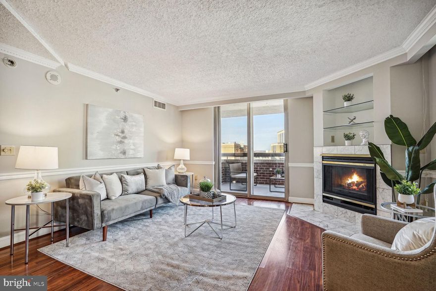 Experience breathtaking Arlington & DC views from the huge 12th floor balcony at The Williamsburg! This spacious 2-bedroom, 2-bathroom layout was just freshly painted with new carpets installed presenting a pristine, move-in-ready home.

Step into the condo greeted by inviting wood laminate floors that complement the sunlit interior. The kitchen features marble floors, stainless steel appliances, gas cooking, Corian countertops, and a convenient breakfast bar overlooking the open living and dining room. 

Enjoy the 180-degree exposure that floods the space with natural light accented by the warmth of a gas fireplace in the spacious living room. Step out onto the wrap-around balcony, a perfect retreat to savor morning coffee or revel in Arlington and DC views of the Jefferson Memorial and partial Washington Monument views.

Retreat to the private owner's suite through French doors, featuring new carpet, a walk-in closet with built-ins, and a spacious en-suite bath offering a newly reglazed tub/shower combo. 

The second bedroom is located on the opposite side of the living space and features a large closet and dual entry bathroom with marble floors and newly reglazed full-sized shower. 

This unit comes with the added convenience of Bosch front load washer and dryer, 1 garage parking space, extra storage and a brand new HVAC replaced in 2023.  The Williamsburg boasts fantastic amenities, including a party room, gym, billiards room, and a large outdoor pool. Situated on a large lot with walking paths on a tranquil cul-de-sac, the building is just 2 blocks from the Courthouse Metro and a five-minute walk to Clarendon’s shopping and night life. Enjoy the community feel of this amazing building while relishing in the proximity to bars, restaurants, parks, and easy access to Rt 50 and Rt 66, providing seamless connectivity to everything Arlington has to offer.