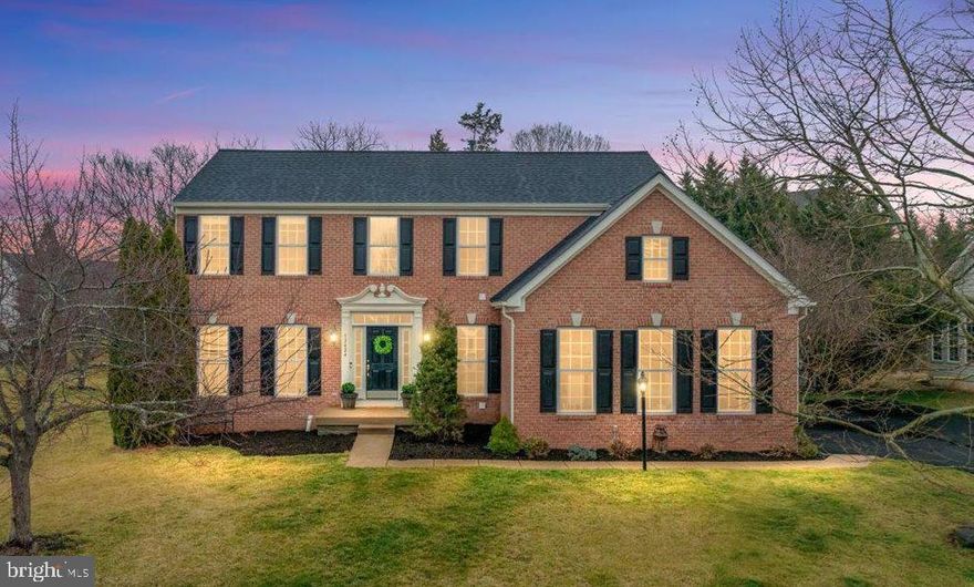 Open House this Saturday & Sunday 1-3PM!  Beautiful brick-front Colonial in sought-after Braemar Tartan Hills! This impressive home welcomes you with a dramatic two-story foyer and a spacious, light-filled layout designed for comfortable living and entertaining. The main level showcases wide-plank hardwood floors throughout, along with elegant formal living and dining rooms. The living room is accented with glass French doors, while the dining room features stylish sliding barn doors that add both character and privacy. The modern all-white kitchen is beautifully appointed with quartz countertops, a marble tile backsplash, stainless steel appliances, and a breakfast bar - and opens to a light-filled sunroom with a vaulted ceiling. From the sunroom, step outside to the deck and patio, creating the perfect setting for summer entertaining and outdoor gatherings. A warm and inviting family room with a gas fireplace provides the ideal space to relax. Upstairs, retreat to the stunning primary suite, featuring a walk-in closet with a custom closet system and a spa-like bath with a floating tub and glass-enclosed shower. Three additional spacious bedrooms and an updated hall bath complete the upper level. The fully finished walkout lower level offers flexible additional living space, including a recreation room, bedroom, and full bath—perfect for guests or a home office. Recent upgrades include: Upper level hall bath (2025), Driveway (2025), Kitchen (2023), Windows around the fireplace and updated mantle (2020), Hardwood flooring main level (2020), Roof (2019), Primary bath (2018). Enjoy an incredible community lifestyle with two pools, including a baby pool, tennis, basketball, and pickleball courts, miles of walking trails, tot lots, a pavilion, and outdoor grilling areas. HOA dues include both internet and cable for added convenience. Located in one of Braemar’s most desirable neighborhoods, this home offers the perfect blend of space, style, and comfort in a vibrant community. Floorplans  - 3D Tour - & Video Walk Through Available!
