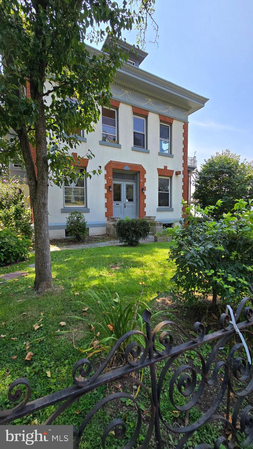 Step into a one-of-a-kind first-floor unit that feels like a castle retreat, located in a beautifully restored historic mansion in the heart of Reading. This unique and updated rental blends timeless architecture with modern comforts. From the moment you enter the hardwood foyer, you'll be captivated by the rich hardwood floors that flow throughout.
The spacious living and dining rooms feature soaring ceilings, a stunning fireplace, and a dramatic chandelier, with stained glass details on select windows that add even more charm. The eat-in kitchen includes white cabinetry and Corian countertops, offering both elegance and functionality.
Two generously sized en-suite bedrooms provide privacy and space. One suite includes built-in shelving and a private bath with a shower. The second suite features a double closet and a large bathroom with an authentic soaking tub and separate shower. Off this bedroom and the living room, a sunroom leads to an expansive private deck with breathtaking mountain views—perfect for relaxing or entertaining.
Additional highlights include a brand-new all-in-one washer and dryer and off-street parking.
This rare rental opportunity offers historic charm, unique character, and comfortable living all in one.