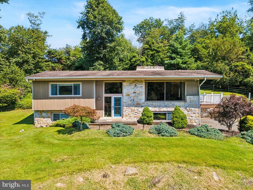 Look at this gorgeous 2,834 sq ft hillside split on a 4.3 acre oasis in Thornbury Twp (West Chester Area School District)!!  If serenity and land are what you love and you enjoy a big, beautiful open floor plan with cathedral ceilings,  amazing views from every window (and many oversized windows), a huge, double sided stone fireplace, a large kitchen with a mega island, an in- ground pool and even a potential for an in-law suite, then this beauty could be the home for you! The cathedral ceilings and hardwood floors are just amazing as you enter the front door.  The huge picture window in the front of the home overlooks the gorgeous grounds and the pool. The dining room is wide open to the gracious kitchen and leads you to a lovely balcony overlooking the pool and ground. The kitchen has plenty of countertop and cabinet space and a beautiful, oversized island and also has sliders to the lovely, serene rear paver patio.  There are 2 choices for a primary suite as both bedrooms are generous sizes and have a full bath.  A lovely above-grade family room also offers plenty of light and a stone fireplace.  The central air is just 2 years new, the pool was painted along with new coping and tile in 2020, and the 2 upstairs full baths were redone in 2019/2020.  This home is a retreat and will make you feel like you are on vacation! The pictures really dont do this home justice. Must see in person!