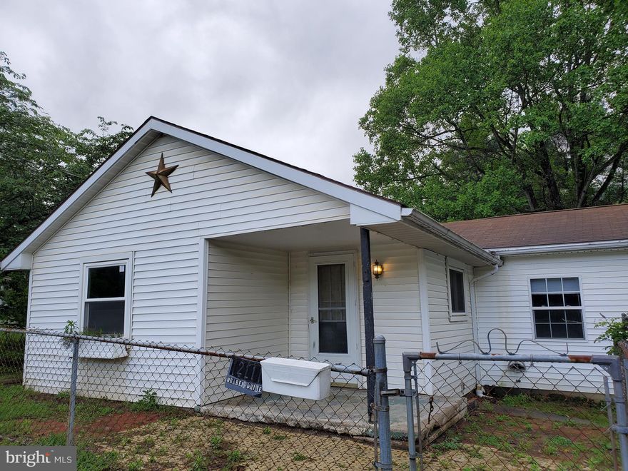 You must come inside to appreciate how spacious this home is! Situated on .27 lot that is fully fenced, this 2-3 bedroom one bath home has mixture of newer flooring, wall to wall carpet, ceramic tile, and laminate, plus paint throughout.