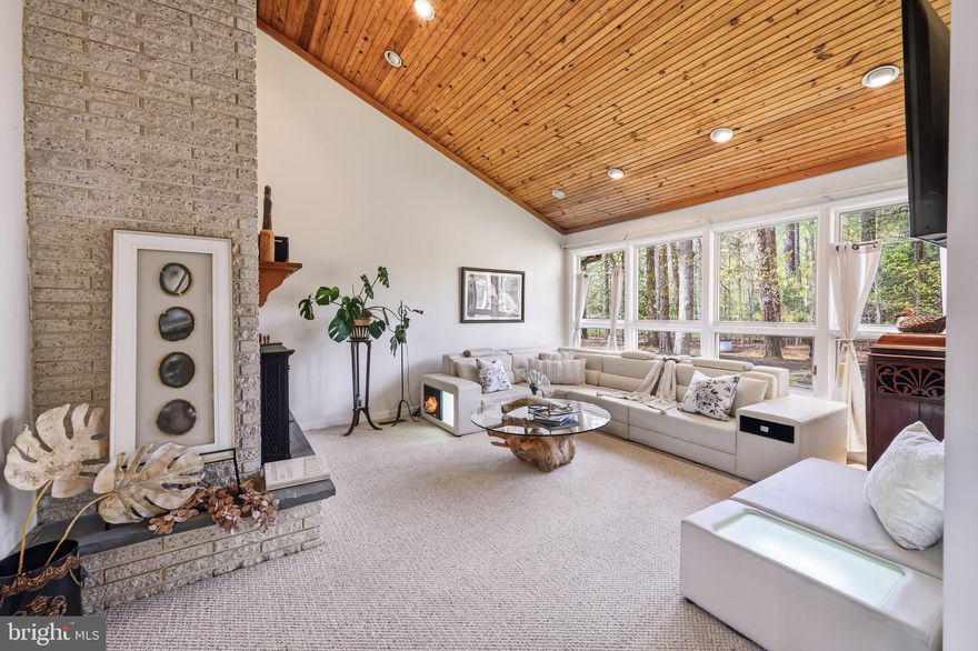 Improved pricing on this beautiful four-bedroom contemporary home, now offered at $725,000. Privately situated on a on a one + acre lot overlooking the 12th fairway of the Links at Perry Cabin golf course, this  light-filled interior residence features a vaulted living room with fireplace, and wood-burning insert for added warmth and comfort, spacious family room and dining room, and a bright sunroom that opens to a relaxing private deck.  The main level primary ensuite includes two walk-in closets and new carpeting installed in 2024, creating a comfortable retreat for everyday living.  Significant 2024 improvements include a new roof and gutters, representing approximately $90,000+ in recent upgrades. Double-pane windows throughout enhance energy efficiency and create a peaceful interior environment.  Home is supported by three HVAC systems professionally serviced and maintained by Shaw's along with two water heaters for enhanced comfort and efficiency. Nestled in a wooded setting that provides both privacy and scenic golf course vistas. The two-car garage offers abundant space for hobbies, storage, or workshop use, while the expansive driveway can comfortably accommodate 7+ vehicles.  A wonderful opportunity to enjoy quiet golf course living just minutes from historic St. Michaels, restaurants, shops and the waterfront.