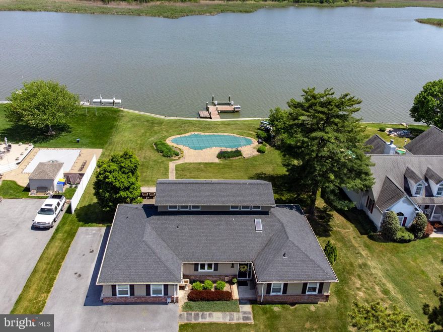 Queen Anne Colony Waterfront. This 4 bedroom/3.5 bath, completely renovated Contemporary/Coastal-style home features an open floor plan with breathtaking views from almost every room. The layout is ideal for entertaining and for daily living. Large kitchen with stainless steel appliances, quartz tops, center island, a River Room, Family Room with fireplace and a wall of glass overlooking the pool, pier and creek. There is a first floor Primary Suite, custom closet system, high-end bathroom. There is another bedroom on the first floor that owners use as a private office. The second floor includes two bedrooms and a full bath and plenty of walk-in storage. House is also improved with a large utility/laundry room, a 1.5 car-garage, a pool bathroom, paved driveway, mature landscaping, a waterside custom gunite pool with heater and paver decking, 10’ x 12’ Shed. The water frontage has bulkhead, pier was built in 2015, 8K boat lift, floating pier, electric. High elevation, protected views across Price Creek, a safe harbor off of the Chesapeake Bay. Turn-key house in arguably the most highly sought-after community in Stevensville, minutes to the Bay Bridge.