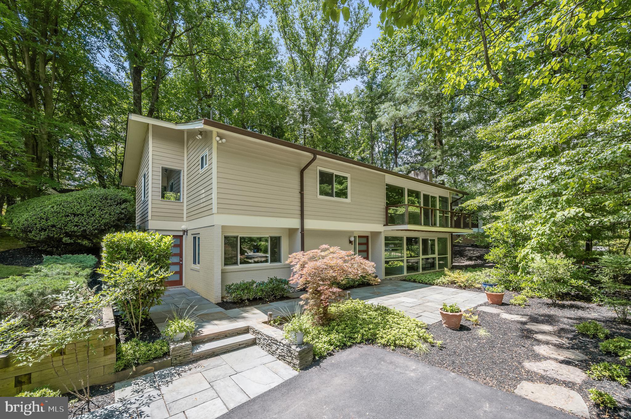 Gorgeous expanded and renovated Valley View model in the quiet heart of the Carderock Springs neighborhood, the largest and best preserved Mid-Century Modern neighborhood in the DC area. This home has one of the best kitchen expansions I have seen in Carderock, with Cabico custom cabinets, tons of drawers, fantastic curved island with breakfast bar. A "great room layout" with vaulted ceiling is open to the living/family room with fireplace and treetop views and balcony. Large dining addition has wall of glass to the back deck and garden. The primary bedroom suite is a true retreat with gorgeous custom built in cabinetry and shelves, a truly spa-like primary bath designed by Sola-Sole Architecture, with curved bamboo wall, pebble stone detail, double sinks, soaking tub and large shower in slate that echoes "Carderock stone". This room is completed by a generous stretched walk in closet. Additional bedroom with renovated ensuite bath and walk-in closet, and powder. room. The floating staircase leads to the walkout level with lovely family room, 2 additional bedrooms (one oversized with separate entrance giving many options for guest/in-law suite or work at home). This is a classic and elegant Carderock home, beautifully expanded and renovated to today's standards. Steps to the pool and clubhouse via path (tennis, pickleball, playground, basketball) and woodland trails in the community. Set on a deep, professionally landscaped corner lot with unbeatable curb appeal! Carderock/Pyle/Whitman schools. Near shops and restaurants in Cabin John, bike path on MacArthur, C & O Canal and great falls, Glen Echo Park. EZ access to DC, Bethesda, 270 Corridor, NoVA.