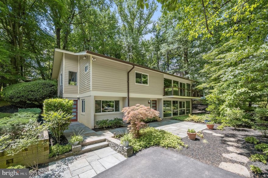 Gorgeous expanded and renovated Valley View model in the quiet heart of the Carderock Springs neighborhood, the largest and best preserved Mid-Century Modern neighborhood in the DC area. This home has one of the best kitchen expansions I have seen in Carderock, with Cabico custom cabinets, tons of drawers, fantastic curved island with breakfast bar. A "great room layout" with vaulted ceiling is open to the living/family room with fireplace and treetop views and balcony.  Large dining addition has wall of glass to the back deck and garden. The primary bedroom suite is a true retreat with gorgeous custom built in cabinetry and shelves, a truly spa-like primary bath designed by Sola-Sole Architecture, with curved bamboo wall, pebble stone detail, double sinks, soaking tub and large shower in slate that echoes "Carderock stone".  This room is completed by a generous stretched walk in closet. Additional bedroom with renovated ensuite bath and walk-in closet, and powder. room. The floating staircase leads to the walkout level with lovely family room, 2 additional bedrooms (one oversized with separate entrance giving many options for guest/in-law suite or work at home). This is a classic and elegant Carderock home, beautifully expanded and renovated to today's standards. Steps to the pool and clubhouse  via path (tennis, pickleball, playground, basketball) and woodland trails in the community.  Set on a deep, professionally landscaped corner lot with unbeatable curb appeal! Carderock/Pyle/Whitman schools. Near shops and restaurants in Cabin John, bike path on MacArthur, C & O Canal and great falls, Glen Echo Park.  EZ access to DC, Bethesda, 270 Corridor, NoVA.