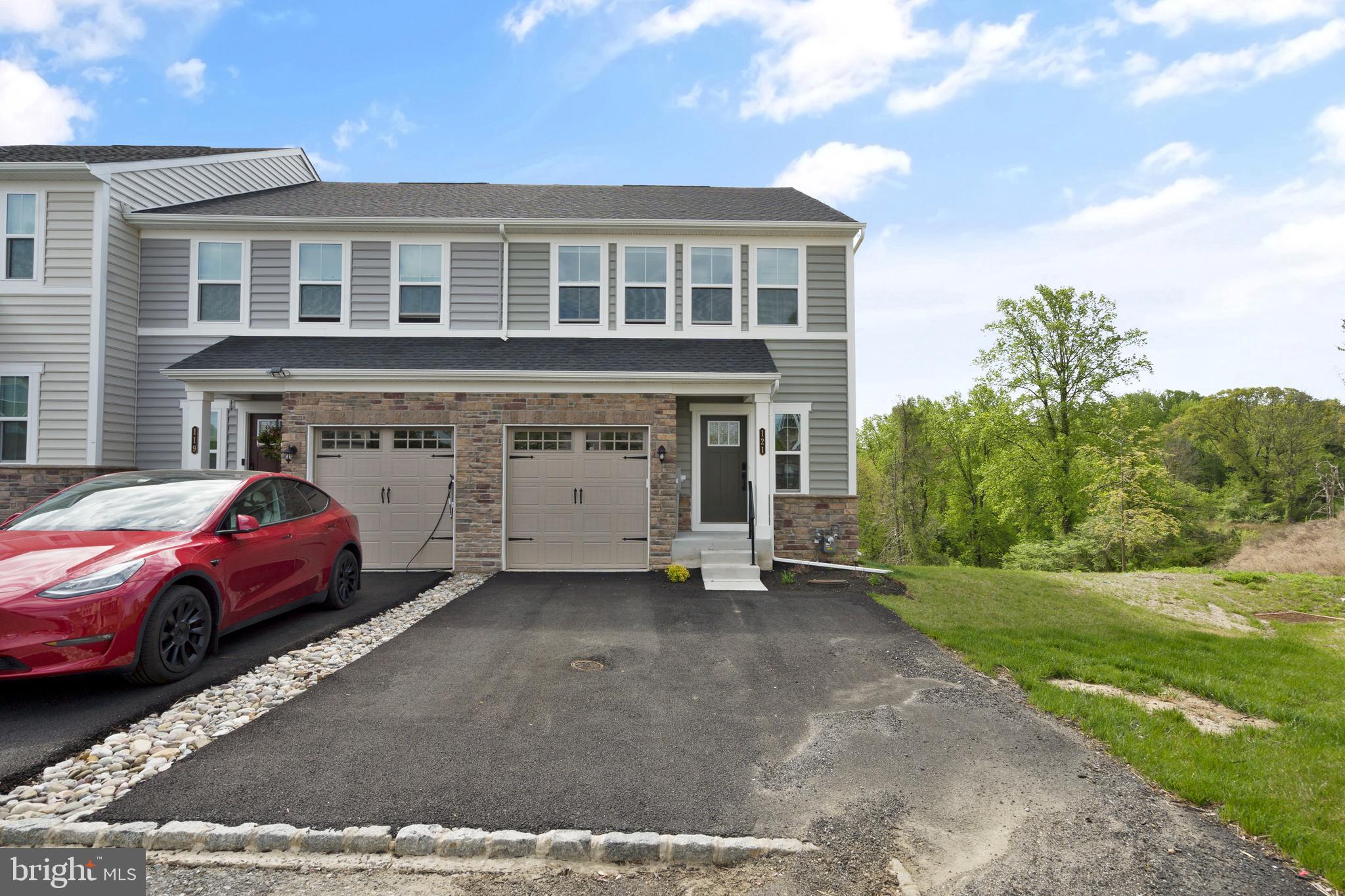Welcome to 121 Kyle Square, Media, PA - Nestled in the newly developed Ponds Edge community, this 3-bedroom, 3.5-bathroom end-unit townhome completed in 2024 by Ryan Homes, offers the perfect blend of modern design, comfort, and convenience. From the moment you arrive, you’ll be impressed by the home’s sleek and stylish exterior, featuring a combination of stone veneer and vinyl siding. Situated at the end of the row, this home not only provides enhanced privacy but also benefits from extra natural light and a more spacious feel. Step inside to a bright, welcoming hallway with neutral paint colors and rich oak hardwood flooring that flows throughout the main level. Interior access from the garage adds everyday ease, while thoughtful upgrades can be seen throughout the home. The beautifully appointed kitchen boasts espresso cabinetry, granite countertops, a 4x12 subway tile backsplash, stainless steel appliances including a gas range and built-in double ovens and a large island that’s perfect for both entertaining and daily use. The kitchen opens seamlessly to the spacious family room and a dedicated dining area, where sliding glass doors lead to a private deck. Enjoy morning coffee or evening drinks with peaceful views of the pond and surrounding tree line. A stylish powder room is tucked off the hallway to complete the main level. Upstairs, the primary suite is a true retreat with vaulted ceilings, oversized windows, plush carpeting, a generous walk-in closet, and a gorgeous primary bathroom featuring a double vanity, espresso cabinetry, and a sleek tiled shower. Two additional well-sized bedrooms share a full hall bath, while a dedicated laundry room offers extra convenience. The fully finished lower level expands your living space even further with a full bathroom, plenty of storage, and sliding glass doors that provide walk-out access to the backyard. With all appliances less than a year old and high-efficiency systems throughout, this home is truly move-in ready. Ponds Edge is conveniently located just minutes from major highways, shopping centers, restaurants, and is part of the award-winning Rose Tree Media School District. This is a home that offers everything—modern finishes, thoughtful design, and a peaceful setting close to it all. Don’t miss your chance to make it yours. Schedule your showing today!