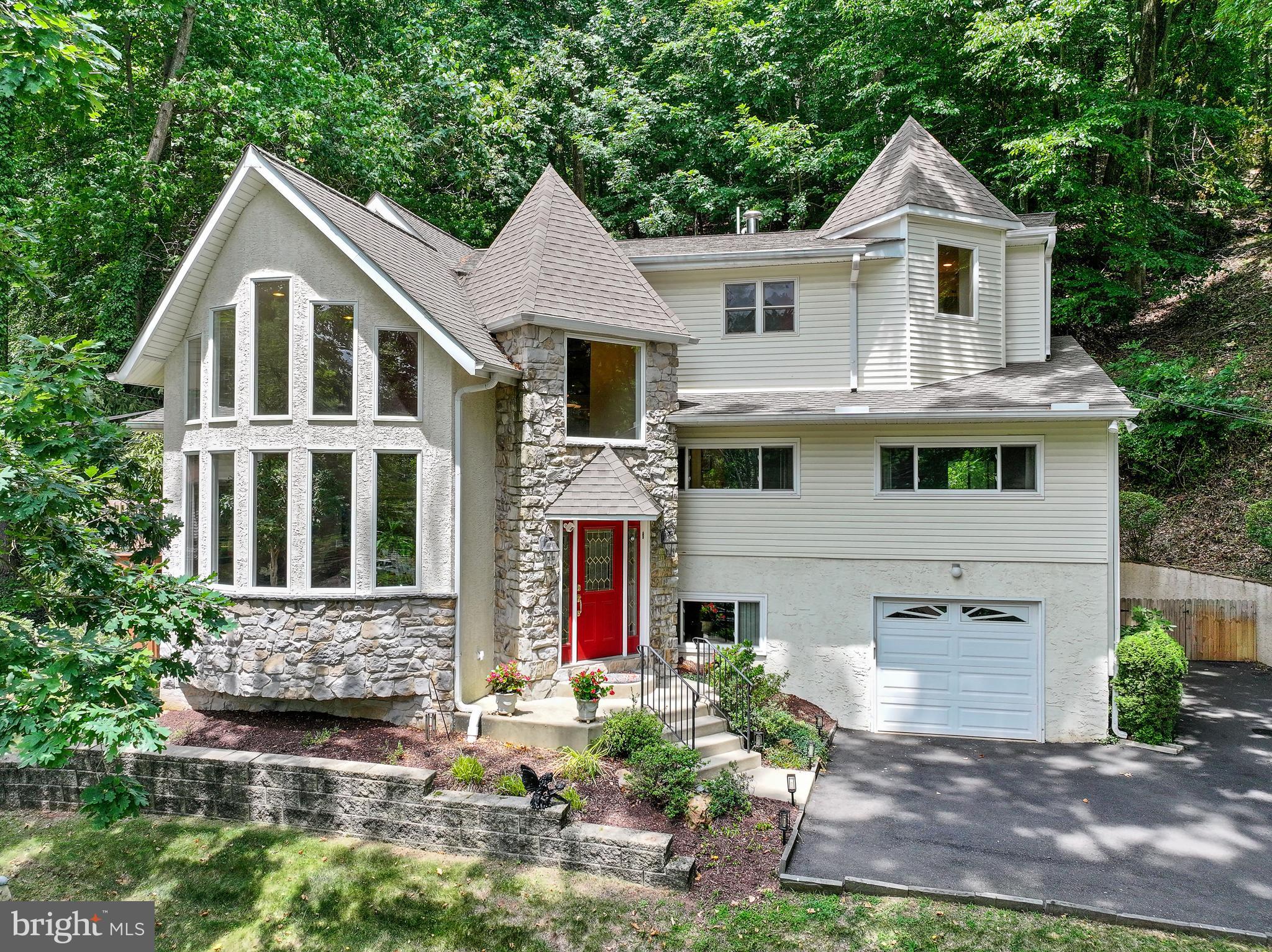 Nestled in a hillside in Gulph Mills, this contemporary 4-bed, 3 1/2 bath home offers 3,589 sqft of modern turn-key living space. Enjoy privacy, captivating wooded views and abundant natural light from every window with minimal yard maintenance at this tranquil residence. Revel in GE Cafe appliances, vaulted ceilings, and hardwood floors. Unwind by the gas fireplace in the living room or entertain on the new Trex-style deck. The primary suite on the 3rd floor boasts walk-in closets and a luxurious bath, while the 2nd floor features 3 bedrooms, one ensuite and a hall bath. The finished lower level offers a family room with a wood stove and "Mad Men" style bar, plus an office, walkout patio, 1/2 bath, laundry and access to a one-car garage. The neighborhood has a park with new playground equipment, tennis and basketball courts, picnic tables and a creek. This great location is only 3 miles to King of Prussia Mall, 6 miles to Wayne, 18 miles to center city and 28 miles to the airport. The esteemed Gulph Mills Golf Club is nearby. Additionally, the property boasts low taxes and is located within the desirable Upper Merion School District, known for academic excellence.