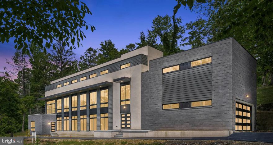 New Price!  Ready for Quick Settlement! This is the home that everyone is talking about.... . Stand out from all the the other stone colonial homes and be different ! True Luxury awaits you at 125 McClenaghan Mill Rd. This stunning new construction contemporary single was carefully designed to feature that highly sought after open floorplan, five total bedrooms (four of which are suites) and has made outdoor entertaining of top priority with several balconies and terraces to enjoy the great outdoors (potential to create an additional rooftop entertaining area if desired). From the moment you pull into the extended driveway, including a two car garage and turn around, you will be impressed with the sleek black and white exterior and the floor to ceiling windows that just flood the home with natural light. Enter through the double door entry into the foyer where you will be greeted by beautiful hardwood flooring, neutral finishes, the open staircase, and the elevator which travels amongst all three levels of the home. Directly to your right is the large mudroom connecting to the garage, and to your left is the first of two beautiful living rooms. A glass slider leads to the rear private outdoor area surrounded by an original stone retaining wall (picture perfect spot to add some candles and enjoy an evening cocktail in peace). Finishing up this level of the home is a conveniently placed half bath, and the first of four bedroom suites with a private exterior entrance. For those needing an in-law / au pair suite, this layout is ideal. The main level of the home is an absolute dream with floor to ceiling windows that line the entire front of the home. Sunlight floods the kitchen, dining room and family room and also provides nice views. The gourmet kitchen is sure to please with Kraftmaid cabinetry lining the walls, quartz countertops and backsplash, a large center island with waterfall edging, and bronze hardware and lighting. The Monogram Stainless Steel appliance package is impressive with a slide-in gas range, hood vent, dishwasher, refrigerator and microwave drawer. Another set of glass sliders leads to a large terrace overlooking the backyard, and great for outdoor entertaining. A bridge from this terrace (to be installed) will lead directly to the terrace for easy access to the beautiful backyard. Our favorite part of this level? The gorgeous sun room completely surrounded by floor-to-ceiling windows and glass sliders that lead to a wrap-around roof deck. Back inside you will find a second half-bath for guests, and a huge attic space that is ready for your imagination. The primary suite sits on this level and comes complete with beautiful views of the backyard, two walk-in closets, and a spectacular en suite bath with walk-in shower, standalone soaking tub and dual sink vanities. The top floor consists of two remaining bedroom suites (one with a massive walk-in closet) and the 5th bedroom that has easy access to the hall bath. Pool has not been operational in years, but the structure is still there (for those who want a pool). Pool is in as-is condition and could certainly be restored. Contact us today to schedule your private tour!