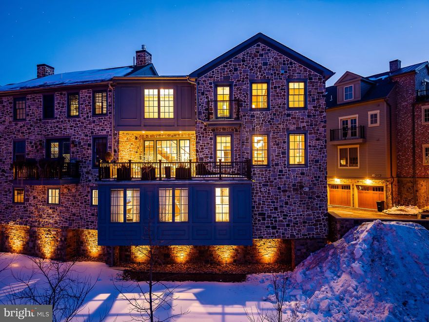 Welcome to 18 W. Mechanic Street, Unit 4, an exceptional waterfront residence at The Falls at New Hope, recipient of the 2023 Excellence Award and masterfully designed by Ralph C. Fey Architects, AIA. Perfectly positioned as a premier corner unit along the tranquil banks of Aquetong Creek, this home offers some of the most captivating views in town, overlooking the water and toward the iconic Bucks County Playhouse. Set just moments away from New Hope’s historic canal path, boutique shopping, galleries, restaurants, and the charming bridge to Lambertville, this location blends natural serenity with vibrant small-town energy.

This custom-built townhome is a showcase of refined craftsmanship, elevated finishes, and modern convenience throughout. The private entrance level features a flexible guest bedroom or study and access to the oversized two-car garage. A striking architectural staircase with 6" floating treads, a custom stainless steel and oak railing, and a dramatic Bucks County stone accent wall creates a stunning visual centerpiece that carries through the home. Designer lighting, custom built-ins, and a cantilevered glass architectural feature enhance the modern aesthetic, while a Lutron automated shading and lighting system and a fully integrated Sonos sound system provide seamless comfort and ambiance at the touch of a button.

The main living level is designed for both everyday living and elegant entertaining, anchored by a sophisticated chef’s kitchen featuring Plato cabinetry, Chantilly quartzite countertops and backsplash with a leathered finish, a statement island, Newport Brass fixtures, and an instant hot water dispenser. A custom wet bar with brass accents adds a luxurious touch for hosting. Just beyond, a partially covered terrace with a gas line for grilling offers a peaceful setting to relax while taking in the sights and sounds of the creek. 

Upstairs, beautifully appointed bedroom suites provide privacy and comfort, including a serene primary retreat with spa-inspired baths featuring luxury tile and stone finishes, radiant heated floors, a steam shower, and a self-heating Japanese soaking tub designed for ultimate relaxation. Thoughtful additions such as built-in closet systems with locking security drawers and a Resource Furniture Murphy bed add both function and flexibility.

Life at The Falls at New Hope offers a rare blend of architecture, technology, and lifestyle. Mornings along the canal, evenings at the Playhouse, and effortless access to everything New Hope and Lambertville have to offer create an experience that feels both vibrant and peaceful. With its award-winning design, exceptional craftsmanship, and breathtaking water views, 18 W. Mechanic Street, Unit 4 presents a truly special opportunity to own one of the most distinctive and luxurious residences in the heart of New Hope.