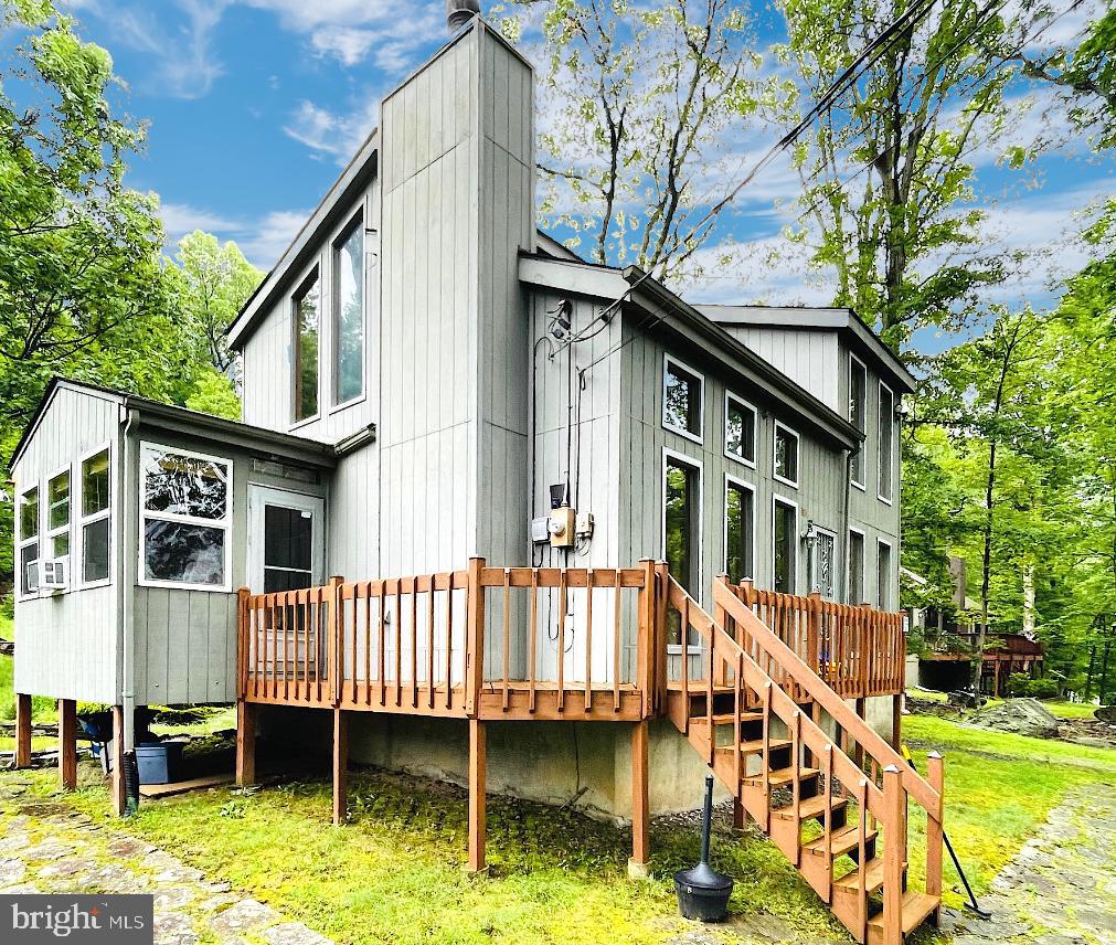 Welcome to your perfect POCONO escape!
Tucked away on nearly half an acre of natural beauty, this stunning 3-bedroom, 2-bath MOUNTAIN retreat offers an unmatched blend of RUSTIC CHARM, modern COMFORT, and resort-style living in the heart of Saw Creek Estates – one of the region’s most sought-after gated communities.
Step inside and be wowed by the OPEN-CONCEPT layout, soaring CATHEDRAL ceilings, and FLOOR-TO-CEILING WINDOWS that flood the home with NATURAL LIGHT and breathtaking views of the outdoors. The real hardwood floors, exposed wood beams, and a stone fireplace with insert create a cozy, lodge-like ambiance perfect for relaxing year-round.
The chef-inspired kitchen boasts granite countertops, a breakfast bar, and seamless flow into the dining and living spaces—ideal for entertaining or unwinding with family!
Escape to the oversized bathroom with a jacuzzi tub for ultimate relaxation after a day enjoying the Poconos. Upstairs, the lofted living room overlook offers a quiet nook with incredible treetop views.
Outside, you'll find a stone patio with fire pit, front deck, fruit trees, natural landscaping, and a private kids’ play area with swings and slide—all designed for memorable moments in your own backyard.
And the best part? You're just minutes from Saw Creek’s world-class amenities, including:
4 Pools (Indoor & Outdoor)
Private Lake with Beach & Boat Dock
Fitness Center & Tennis Courts
Clubhouse with Bar, Lounge, Dining & Game Room
Playground, Basketball, and More!
Whether you’re seeking a full-time residence, a weekend getaway, this home has it all—nature, style, space, and the lifestyle you deserve.
Don’t wait—homes like this don’t last long! Schedule your private showing today and experience the magic of Saw Creek Estates living!