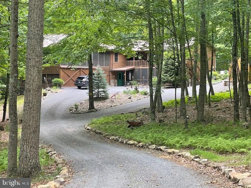 197 Stonewall Trail is in the Middle Cove of Lost River Valley.  2 hours from Northern Virginia.  
The entrance to Stonewall Trail is directly off a paved well-maintained county road.  After passing through a park-like, landscaped setting, you arrive at this two-level, three bedroom/2-bath home, which is the second property on Stonewall Trail.  An idyllic driveway brings you to the house. 
This private wooded property is beautifully maintained.  Little to no maintenance necessary to keep this property in great shape.  All systems/appliances have been carefully maintained/updated.  Metal roof, whole house generator, two car garage, living room with wet bar, open concept kitchen/dining area, huge, screened porch for entertaining.   Lower level has a Primary suite, large walk-in closet, sitting room.   This is a stellar property and priced to sell.