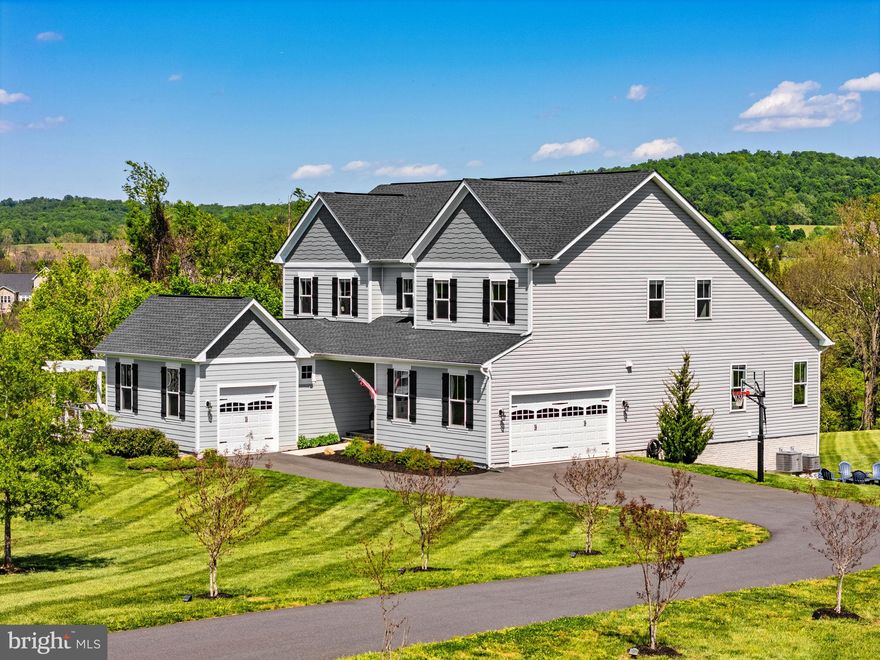 Welcome to the desirable Waterford Manor community, this exceptional estate offers a rare blend of refined luxury and serene countryside living, just minutes from historic downtown Leesburg, yet beautifully set within the rolling landscape of Waterford. If you've been looking for the perfect multi-generational home, this is it. 

Positioned on over three acres of sweeping, panoramic grounds, this distinguished Weymouth model presents a thoughtfully curated living experience defined by scale, light, and architectural elegance.

The expanded main level, enhanced by a 4-foot extension, unfolds with vaulted ceilings, abundant natural light, and a striking fireplace, creating a sophisticated yet inviting atmosphere. At the heart of the home, the gourmet kitchen is designed to impress, featuring two oversized islands, premium finishes, and seamless flow for both intimate gatherings and grand entertaining. The main-level primary suite serves as a private retreat, highlighted by dual walk-in closets and an abundance of natural light, with tranquil views that bring a sense of calm and connection to the surrounding landscape.

A standout feature of the home is the private multi-generational suite, thoughtfully designed with its own kitchen, full bath, washer and dryer, and dedicated garage access, ideal for extended living, guests, or a private workspace. This space is further enhanced by direct access to a private deck and pergola, offering a peaceful outdoor extension perfect for quiet mornings or evening unwinding.

Upstairs, four well-appointed bedrooms provide comfort and flexibility, including one with a private en-suite. A secondary laundry area and an open loft space enhance everyday functionality, while open rail staircases and upgraded trim and door selections contribute to the home’s custom, elevated aesthetic.

The lower level continues the home’s expansive footprint, offering a spacious recreation room, full bath, and a framed option for a future seventh bedroom, allowing for seamless expansion as needs evolve. Recent updates include new carpeting throughout the lower level and staircases, as well as the addition of a tankless water heater.

Outdoor living is nothing short of exceptional, with over $55,000 invested in premium all-weather decking and a custom pergola, creating a stunning setting for outdoor entertaining or quiet relaxation. The property is further enhanced by a mostly flat, usable landscape and a charming creek feature, adding both natural beauty and a sense of tranquility rarely found at this level of convenience.

This is a rare opportunity to own a distinctive, thoughtfully upgraded estate in one of Western Loudoun’s most coveted communities, where privacy, design, and lifestyle converge effortlessly.