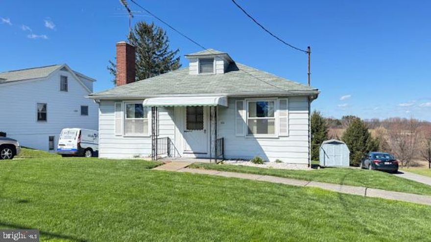 This charming bungalow cottage, built in 1958, offers a delightful blend of comfort and character. Inside, you'll find two cozy bedrooms and a full bathroom, complemented by traditional wood floors and a welcoming fireplace, perfect for those chilly evenings. The kitchen features essential appliances, including a stove, refrigerator, making meal prep a breeze.  This home has been lovingly cared for.  Fireplace his equipped for gas hookup-- Step outside to enjoy a spacious lot for extra storage or hobbies. The attached garage and ample driveway space provide convenience for parking. This home is just a short stroll from local parks, ideal for outdoor activities and community gatherings. Excellent schools are nearby, ensuring quality education for all. With easy access to public services, this location truly embodies the essence of community living. Experience the warmth and charm of this inviting home, where comfort meets convenience. Public sewer and well