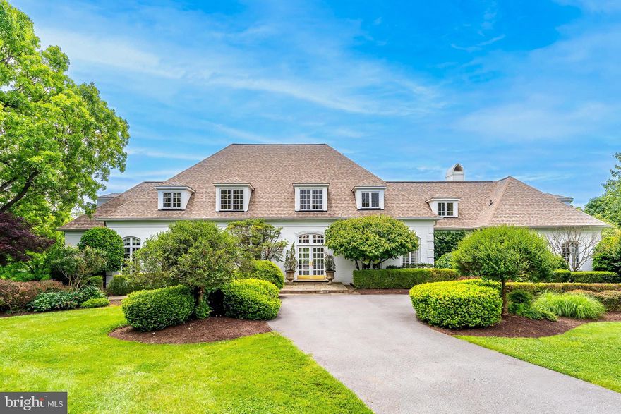 Major price adjustment AND a brand NEW roof with transferable warranty! It is not often a home with this level of craftsmanship, space, and charm, set on a superior two-acre lot backing to parkland, becomes available. Located in the coveted Wootton school cluster, this expansive and elegant residence offers over 10,000 square feet of beautifully designed living space at the end of a quiet cul-de-sac, offering both privacy and connection to nature.

The home welcomes you with a grand two-story foyer, setting the tone for the thoughtfully designed interior. The formal living room features hardwood flooring, crown molding, and floor-to-ceiling windows that flood the space with natural light. Adjacent is a dining room equally refined with crown molding and wall-to-wall windows, ideal for hosting gatherings both large and small.

A butler’s pantry with additional cabinetry leads to the heart of the home: a gourmet kitchen equipped with granite countertops, a center island, Sub-Zero refrigerator, gas cooktop, abundant wooden cabinetry, and a built-in desk space. A sliding glass door opens to the expansive deck, while the kitchen sink overlooks the backyard and serene wooded views, creating a perfect blend of function and beauty.

Off the kitchen is a charming breakfast area with two-story ceilings and an oversized stone fireplace—a stunning focal point for everyday living. A back staircase leads conveniently to the upper level.

At the center of the home is the great family room, featuring vaulted ceilings, a striking fireplace with a wooden mantle and stone surround, and tall windows that frame the natural landscape. French doors lead directly to the deck, creating a seamless indoor-outdoor flow. A wet bar with a beverage refrigerator and sink makes this space ideal for entertaining.

Also on the main level is a powder room, a dedicated office, and a laundry/mudroom off the three-car garage, complete with additional cabinetry and storage.

The main-level primary suite is a true retreat. The bedroom includes two walk-in closets and French doors leading to a sitting room with vaulted ceilings, a gas fireplace, and its own private deck. The en suite bathroom features dual vanities, a large soaking tub, a separate glass-enclosed shower, and heated tile floors for year-round comfort.

Upstairs, you'll find four generously sized bedrooms, each offering vaulted ceilings and custom built-in window benches that add charm and character. Two large hall bathrooms provide ample space for family or guests. An additional upper-level space is perfect for a home office, playroom, or potential bedroom. At the end of the hall is an expansive bonus room above the garage, outfitted with extensive built-in cabinetry, offering ultimate flexibility for your lifestyle needs.

The fully finished walk-out lower level is designed for multi-generational living or extended stay guests. It includes a second full kitchen, a spacious recreation room with a gas fireplace, doors leading to the backyard, a bedroom with full en suite bathroom, exercise room, two large storage rooms, an additional set of washer and dryer, and even a separate garage—perfect for yard equipment or workshop space.

One of the home’s most unique and desirable features is the private path from the backyard that connects directly to the Muddy Branch Trail, offering direct access to miles of scenic parkland—right from your own backyard.

This home is a private retreat surrounded by nature, yet still incredibly convenient to Kentlands, Downtown Crown, Rio, and major commuter routes—the best of both worlds!