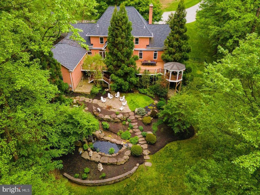 Welcome to 7 Padonia Woods Court! This stunning custom-built brick home is nestled at the end of a peaceful cul-de-sac in Padonia Woods. Spread across 3.2 acres of land, this humble abode boasts 6 bedrooms, 4.5 bathrooms, and an oversized 3-car garage. The living room, dining room, foyer, and primary bedroom feature exquisite custom-designed coffered ceilings, while the primary bedroom, primary closet, and dining room are adorned with custom drapes. You'll also appreciate the wide plank hardwood floors throughout the first and second levels.
 
The house has undergone extensive renovations including the design of a large, open-concept dining room. The main fireplace has been redesigned with floor-to-ceiling rock tile and marble, and a motorized chandelier lift has been installed in the main foyer. Each room features LED lighting, and the primary bedroom has two custom walk-in closets. Bedrooms have California-style closets, and the house is wired with Cat6 network, WiFi access points, central alarm, security cameras and central audio system.
 
The basement has undergone a complete renovation and features a new bathroom, Italian tile floor, custom bar, and game room. There's also a 12-seat ultra-high-definition home theater with a 120" screen for your entertainment needs. The backyard is a true oasis, complete with a large double deck and gazebo combination. Motorized awnings overlook Koi fish ponds with waterfalls and a Japanese garden. You can take in the gorgeous fall and winter scenery from the comfort of the jacuzzi tub on the lower patio. There's even a fenced-in side yard for your furry friends or children.
 
Additional updates include energy-efficient double and triple-pane windows and a brand new roof with a 50-year shingle and 6-inch gutters installed in 2018. Geothermal heating and cooling. This home is truly a one-of-a-kind gem that you don't want to miss out on!