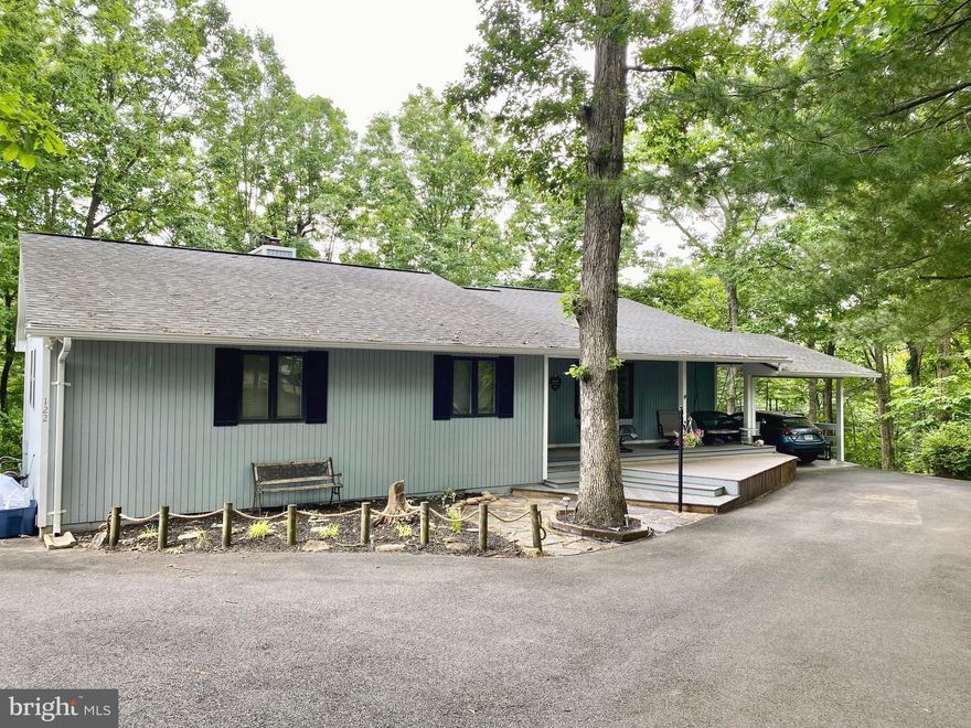 This spacious rancher in Lake Holiday offers ideal one-level living with a modern open-floor plan. Featuring 3 bedrooms and 2.5 updated bathrooms and kitchen, it combines comfort with practicality. The open floor plan, sunroom, and deck provide ample space for relaxation and entertaining, all on a single level. The separate laundry room is also located on the main level.  Enjoy the serene seasonal water views of the 240-acre lake from the back deck. Cozy up by the wood-burning fireplace with built-in bookcases. The finished walkout basement may be used as an additional bedroom, recreational space, and/or storage.  Large front porch is also an ideal spot for entertaining.  Community amenities include a clubhouse, disc golf course, beach areas, boat ramp, tennis courts, hiking trails, and a dog park. Don't miss this opportunity for effortless lakeside living.