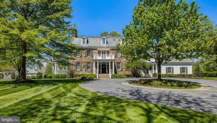 White Oaks — is a distinguished stone estate originally built in 1905 set on just under 9 private acres, impeccably maintained and thoughtfully renovated by Delbert Adams. This extraordinary home showcases exquisite millwork and timeless craftsmanship throughout. The main level features elegant formal living and dining rooms, each with its own fireplace, a handsome den, and a sunken family room anchored by a striking stone fireplace with sweeping views of the surrounding property. The gourmet chef’s kitchen is designed for both function and beauty, boasting a massive center island, high-end appliances, and a charming breakfast nook with a built-in banquet, perfectly positioned by a large bay window. A well-appointed mudroom—with its own private entrance—connects the kitchen and garage, adding convenience and additional storage. Above the  four car garage, a versatile loft provides the perfect space for an exercise room, office or guest suite and powder room. Upstairs, the primary suite is a true retreat, complete with a sitting room, expansive walk-in closet, and a luxurious bath. A second en-suite bedroom and a highly multifunctional laundry room   completes this level. The third floor offers three additional bedrooms, including one en-suite,  providing flexible living arrangements for family or guests. The outdoor living experience is equally impressive, with bluestone patios and covered porches and elegant stone retaining walls surrounding the home, creating seamless indoor-outdoor flow. Enjoy resort-style amenities including an in-ground pool, hot tub, a fully equipped pool house.  Adding to the estate’s versatility is a handsome carriage house/barn, complete with its own kitchen, family room with over sized fireplace, and an upper level that can serve as a bedroom with full bath, private workspace, or studio. This exceptional property is rich in history and finished to absolute perfection, this one-of-a-kind property embodies character, modern luxury and timeless elegance.