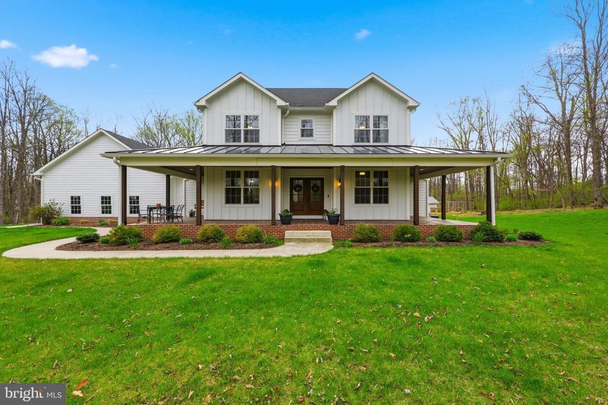 Welcome to 58 Blessing Lane, an exceptional custom-built home situated on just over 3 private acres off Arden Nollville Road. Built in 2019, this beautifully designed property offers the perfect combination of peaceful country living and convenient access to nearby amenities. Upon arrival, you are greeted by a striking exterior featuring an oversized three-car attached garage and a wraparound front porch enhanced by a metal roof, brick accents, finished wood ceiling, and stamped concrete, providing both durability and timeless curb appeal. The home’s interior showcases a thoughtfully designed open floor plan filled with abundant natural light. A formal dining room is positioned just off the entry, offering an elegant space for entertaining. The centrally located living room features a gas fireplace with a refined shiplap surround, creating a warm and inviting focal point. The gourmet kitchen is well-appointed with white granite countertops, dark stainless steel appliances, and custom cabinetry. Adjacent to the kitchen is a casual dining area ideal for everyday use. A functional mudroom/drop zone includes an oversized pantry, a spacious laundry room, and direct access to the attached garage. Located just beside the living room and through the stunning French doors, a covered rear porch features stamped concrete and a beautifully finished wood ceiling, creating an inviting outdoor space perfect for relaxing or entertaining. The main level includes a generously sized secondary bedroom and a full bathroom, as well as a luxurious primary suite. The primary bedroom offers ample space, large windows, and a sliding barn door leading to the en-suite bath, which features white tile flooring, a soaking tub, an oversized glass shower, dual vanities, and a large walk-in closet. The upper level offers two additional bedrooms, each with oversized windows and barn-style closet doors, along with a shared full bathroom featuring dual vanities and a tiled tub/shower combination. A versatile bonus room provides flexibility for use as a home office, playroom, or additional bedroom. In the upstairs hallway, convenient attic access allows for additional storage. The unfinished basement offers easy access to utilities and additional space complete with extra-tall ceilings, a home gym, and workshop. A bathroom rough-in is already in place, providing excellent potential for customization and future finished living area. Surrounded by mature trees, the property offers privacy and a serene setting while remaining conveniently located near town. This property presents a rare opportunity to own a well-crafted home with acreage, modern finishes, and functional design.  Don't miss out, schedule your private showing today!