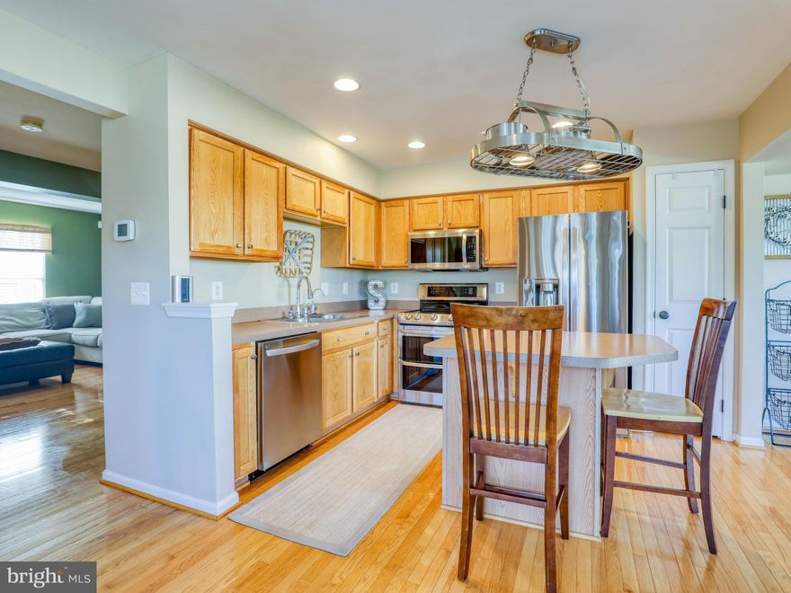 A four-bedroom, end-unit townhome in the desirable Fairfax Crossing neighborhood is a rare find, let alone one with so many nice features! This home is being sold by its original owners, and the love and care they have put into it really shows. The main level has hardwood floors throughout, spacious living areas with plenty of light and extra space to spread out, and a kitchen with newer stainless steel appliances and an island with seating. The kitchen/dining area connects to a freshly stained 10x12 foot deck, and the entire backyard is enclosed by a vinyl privacy fence. Upstairs is the owner's suite with two walk-in closets and an en-suite bath with double vanity and soaking tub, plus a second bath and two additional bedrooms with ceiling fans. The first level features laminate plank flooring throughout, another bedroom with 2 windows, an updated half bath, an access door to the backyard, laundry area, rec room space, and entry to the attached garage. Right across the street are several visitor parking spots, a playground, the school bus stop, and the community mailboxes, making the location of this home all the more convenient. Commuting north or south is a breeze with easy access to Rt. 9, along with lots of shops and restaurants located only minutes away. Start packing now because this extremely well-maintained home can be yours! *Carpet will be replaced with new, similar-color carpet before closing.*