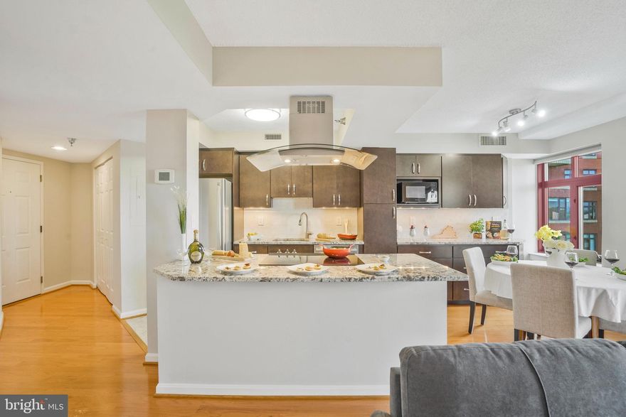 Captivating corner-unit, 9th floor, 1-level condo in The Charleston 2 bedrooms, 2 full baths centrally located between the Courthouse & Clarendon Metros!  Freshly painted, new carpet (2023), open floor plan, granite countertops, island, undermount lighting, tile backsplash, wood floors, chef’s hood, island with seating, stainless steel appliances, in-unit front loading washer & dryer, TV cord management in living room & primary bedroom, floating shelves, bonus storage #44 in storage area 2, assigned parking space #37 near the elevators, perfectly nested between Court House Metro & Clarendon Metro!
As you enter the light & airy condo watch the sun bounce on the beautiful hardwoods to introduce this rare and expansive open kitchen, dining & living areas.  The generous granite countertops & cabinet space seamlessly flow into the dining room while the counter height island seating housing your range to entice guests with aromatic cuisine and relaxing conversation.  
Step onto your new plush primary bedroom carpet then curl up with your favorite author on your chaise lounge.  This sweeping retreat offers 3-closets, reading nook, large windows with sky views, primary en-suite with spacious dual vanity, floating shelves, linen closet, custom tile to ceiling in shower/tub, shower niche & shelving.
The second corner bedroom offers gorgeous views from every corner and within steps to a gorgeous full bath with floor to ceiling tiled shower and shower niche. 
Sunroom/balcony with panoramic views is the perfect spot to ease into your day with an espresso & fresh fruit. 
Pool, fitness center and front desk concierge all included with your condo fee. Premier location to both the Courthouse Metro and the Clarendon Metro!  Centrally located access to Rocky Run, Whole Foods, Apple Store & many shops restaurants and entertainment.  Easy access to I-66, I-495, I-395, Reagan National Airport, D.C., and Georgetown.