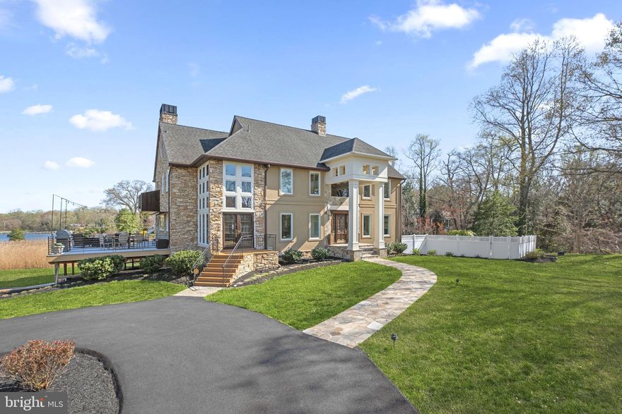 Luxury Waterfront Home on Ulmstead Point - Unbeatable Views & Location! Imagine waking up to stunning Magothy River views every day in this custom craftsman home located in Ulmstead Estates. 796 Canvasback Court offers a coastal flair and breathtaking, expansive views of the Magothy River that will enchant you from the moment you arrive. Situated on a sprawling 1.6 acres of flat waterfront, this property is an entertainer's dream, featuring numerous decks perfect for outdoor gatherings, and a relaxing in-ground pool to enjoy those warm summer days. A true summer paradise with newly completed salt water pool complete with spa, relaxing sun shelf, cascading water feature and travertine pool deck, the perfect place to unwind or entertain this season! With 50 feet of pristine water frontage, your access to the river is unparalleled.  For the boating enthusiast, your 100' pier is complete with water & power, ample boat parking with multiple slips, a boat lift & a jetski lift!  Step inside to discover 4 beautifully finished levels, boasting 5 spacious bedrooms with 4 full and 1 half bathrooms. The open-concept main level is designed to maximize the incredible views, with each room offering a picturesque backdrop. A true chef-inspired gourmet kitchen, a culinary haven equipped with Viking range, Sub-Zero refrigeration, dual dishwashers, and an abundance of prep space designed for creating culinary masterpieces. Journey to the upper levels where you'll find the primary suite a relaxing sanctuary with a spa like private en suite bathroom. 3 additional sizable rooms, an updated hall bathroom, a dedicated private home office, plus an additional rec room for entertainment or relaxation. For a truly unique experience, ascend to the widow's walk rooftop deck, accessible through the charming top-floor screened porch, where you can soak in the panoramic views of the Magothy River. The lower level offers even more, including an additional flex space making an ideal second home office, gym or guest suite, a newly completed full bathroom and ample storage space complete with access to your 2 car garage.  Lawn irrigation will keep your grass green year round. Two whole house generators offer peace of mind no matter the weather. This exceptional property offers the perfect blend of luxury, comfort, and waterfront living. Don't miss the opportunity to make this your forever home!