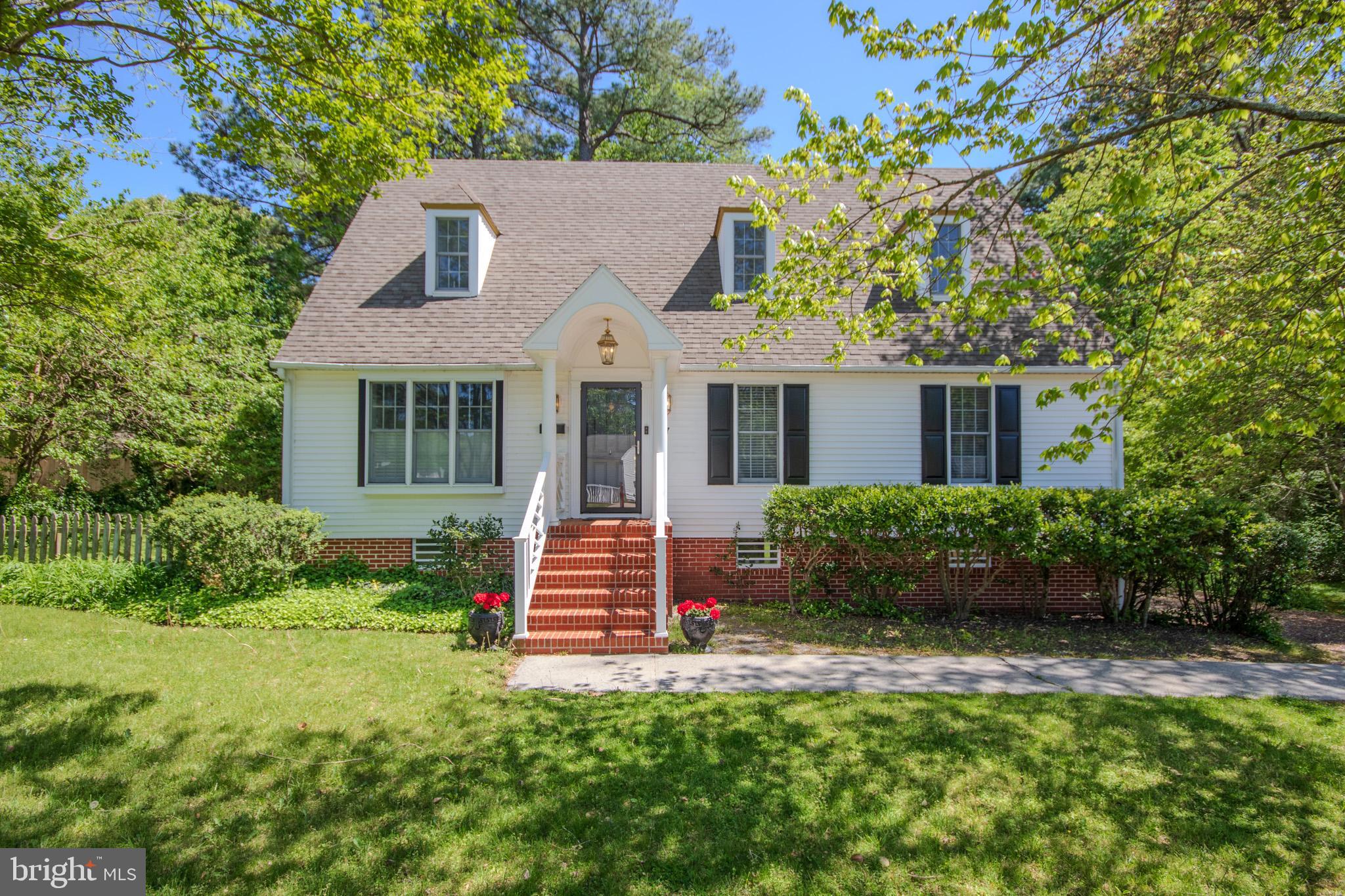 *Back on the market at no fault of the seller. Welcome to 907 Riverside Rd. Very well maintained Cape Cod with 3 bedrooms and 2 full baths. It has 1677 Sq. Ft. and a basement with 520 sq. ft. of finished area and 598 sq. ft. of unfinished area. The finished part has painted white walls, walk out French doors. Unfinished portion has workshop area and Rinnai Tankless Water Heater. This home has 2 zoned heat pumps and central air. In 2019, the first floor had extensive remodeling to include crown molding, hardwood floors, shutters in living/dining room, wainscoting, and primary bedroom with primary bath with shower and walk-in closet. Cold nights can be made cozy with wood fireplace in the den off from the kitchen. The gourmet kitchen is every chef’s dream come true. White high-end appliances include built-in microwave, opposite wall has a refrigerator with bottom freezer, filled with double ovens, and gas cooktop in the middle island of kitchen with unique countertop for covering, when not in use. Three types of white Wilson Art solid surface countertops just sparkle under the white Wolf Design Cabinets, with beautiful backsplash, adding texture and depth to the space. A large central island serves as a focal point for both food prep and casual dining with glass shades, hanging from above, adding an elegant touch. There is also an eat-in area as you enter the kitchen with French doors, leading a spacious deck with awesome views of the backyard. Mature landscaping and a little foot bridge offers a walk across the creek that runs through the backyard. When sitting or dining outside, no one can believe that you are close to downtown Salisbury. Before you leave, don’t forget to venture upstairs with the new carpet upstairs, laundry with front loading washer and dryer, plus cabinets for extra storage. Two bedrooms with ample closet space and dormer windows complete the Cape Cod feel. Another full bath is in the hallway. The fresh paint of soft colors finishes relaxing mood of the second floor. One interesting surprise await you downstairs. On the kitchen island, plans for the missing garage and powder room have already been completed, before the sellers suddenly decide to move in 2024. This year in 2025, seller has made numerous updates including new luxury vinyl plank flooring in primary bathroom, upstairs bathroom and laundry room second floor, new shower door installed in the primary bathroom, upstairs bathroom has new faucet/fixture and new lights over new framed mirror, and new front storm door plus new hardware on interior front door, screens replaced in both bathrooms, new Kitchen Faucet and two new posts on rear deck. Also repairs have been completed including checking attic fan, ice maker hooked up and water line, plus electrical repairs and plumbing repairs per previous Professional Home Inspection Report. Perfect location for new employees for Tidal Health or Salisbury University. What more could you ask for that honors the perfect Cape Cod with its historic roots while offering a modern twist. Call today, before someone else purchases your dream home!