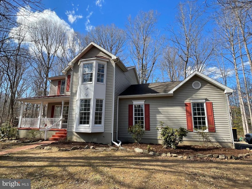 Nestled in the serene enclave of Blue Ridge Shores, this exquisite Colonial-style residence offers a harmonious blend of luxury and comfort, perfect for those seeking an elevated lifestyle. This gated community surrounds beautiful Lake Louisa with all of the recreational amenities.  With a major renovation completed in 2024, this home radiates modern elegance while maintaining its classic charm. (New Architectural Roof 2025, New Skylights 2025, Kitchen updated 2024, Baths updated, new carpet installed on UL 2024) Step inside to discover a welcoming, open floor plan that seamlessly connects the living spaces. The inviting front porch leads to the heart of the home which features a gourmet kitchen adorned with a spacious island, perfect for culinary enthusiasts. Enjoy leisurely breakfasts in the sunny morning room enhanced by abundant natural light, thanks to strategically placed skylights equipped with electronic shades.   Host formal dinners in the separate dining room, where memories are sure to be made. Or you can make this your dedicated home office overlooking the lush yard.  The living room with the cozy gas fireplace, creates a warm and welcoming atmosphere. Enjoy the privacy of the 3-season screened porch.  Retreat to the primary suite, a true sanctuary, complete with a vaulted ceiling and luxurious en-suite bathroom featuring both a jetted tub and a walk-in shower. Two additional spacious bedrooms and an updated hall bath complete the upstairs. The exterior of the property is equally impressive, set on a generous 1.03-acre corner lot that backs to lush trees, providing a sense of privacy and tranquility. Enjoy outdoor living on the expansive deck and patio, perfect for entertaining or simply soaking in the peaceful surroundings. The property also features a quality-built outbuilding which makes for a great shed and workshop, or private studio--the uses are endless adding character and functionality to the property.  For those who appreciate an active lifestyle, the community amenities along the shores of Lake Louisa are unparalleled. Enjoy access to three sandy beaches, boat ramps, and a variety of recreational facilities, including basketball , volleyball, pickleball, and tennis courts, jogging paths, and picnic areas too! With Lake Louisa just moments away, indulge in canoeing, kayaking, boating, swimming or fishing, all while surrounded by nature's beauty. This home is not just a residence; it's a lifestyle. With an attached side-load, oversized garage (12' tall) and a circular driveway, convenience is at your fingertips. The property is meticulously maintained, ensuring that you can move in and start enjoying your new home immediately. Experience the perfect blend of luxury, comfort, and community in this stunning Blue Ridge Shores residence, where every detail has been thoughtfully curated for an exclusive living experience.  This property comprises 4 lots, allowing you to develop it into your personal dream property.  The convenient, central location so near Fredericksburg, Charlottesville, Culpeper, and Richmond makes this a perfect commuter's choice.  Plan to tour today, and vacation all year long!