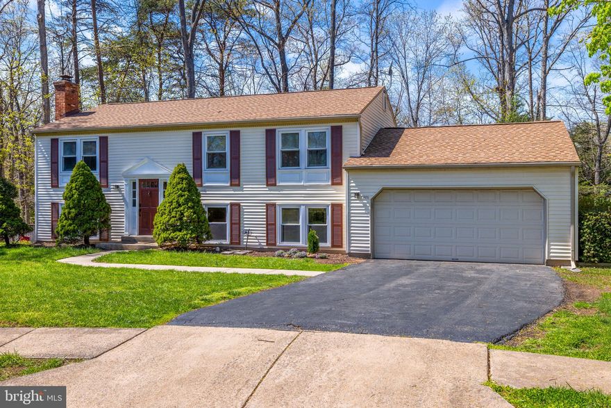 5/4 OPEN HOUSE CANCELED.  Welcome to this beautiful home, perfectly situated at the end of a quiet cul-de-sac offering privacy, space, and modern updates.    Step inside to an open, light-filled layout featuring newer hardwood floors, recessed lighting, and fresh professional paint throughout. The fully updated kitchen shines with quartz countertops and stainless steel appliances, making it ideal for cooking and entertaining. The main level leads to a private deck with scenic views of mature trees & patio with fire pit, your own peaceful outdoor escape. The bathrooms have been fully renovated with modern tile, vanities, and sleek fixtures for a clean, contemporary feel. Downstairs, the finished basement offers a cozy wood-burning fireplace, a custom stylish bar w/ built ins,  two bonus rooms, a full bath, and a spacious laundry/storage room leading to the the two-car garage w/ built-in storage and a tool organizer.  With thoughtful upgrades throughout and minimal maintenance required, this move-in-ready home checks all the boxes for comfort, flexibility, and style.  All updates in home, kitchen, flooring, bathrooms & more completed in 2023. Hurry & See!