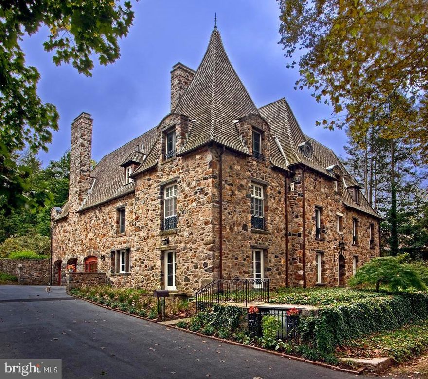 “Kerwalls” may be the most impressive home on the market today. Set on two parcels and a full acre in the Borough of West Chester’s sought after Northeast quadrant, this peerless property includes 5 bedrooms, 3.2 baths and all the luxurious amenities of the modern world, with all of the elegance, class and charm of a world gone by. Built in 1925 by a woman who modeled it after her family’s ancestral home in France, Kerwalls features architectural components imported from France and England such as the main staircase, Great Room flooring, and several mantels. The French Norman style home, with its steep wood shake roof, was built with fieldstone collected from the remains of two nearby mills and one of two found mill wheels is used as a soothing water feature in a stone wall. The second is in the front walkway. One of the home’s former owners was the founder of the West Chester Garden Club and her influence remains in the gorgeous landscaping which creates numerous intimate spots and ensures the privacy of the property. The gardens provide the gracious feel of a country estate. The current owners undertook an extensive, award-winning, eight month long renovation. The renovation included full-house ducting for a 15-ton WaterFurnace geothermal heating and cooling system and installing a 10.4kW solar array with online monitoring. They also repointed the entire stone exterior and undertook a full-house replastering and painting project. Not deterred by arduous tasks, they also rebuilt the entire substructure under the Kitchen, basement to ceiling, that included the repointing and parging of the basement and also the two-car garage. Once completed, the owners added an incredible gourmet kitchen with exposed stone walls, soapstone counters, Tasmanian Blackwood breakfast bar, and high-end appliances including a Wolf 48” gas range, Miele dishwasher, and SubZero refrigerator. Numerous practical improvements were also made, such as moving the Laundry to the second level, adding a first-floor powder room and mudroom … the list goes on! The home’s interior displays its European roots with high ceilings, floor-to-ceiling windows, eight fireplaces, gorgeous wood flooring throughout, and more. Outside, park-like features that make Kerwalls so unique include a grass courtyard with stone walls, three water features, an outdoor fireplace, and a rear patio with a fountain. Come home to your own private park within easy walking distance of downtown West Chester! Unparalleled in its quality and unique features, and a winner of the prestigious West Chester Downtown Foundation’s award for the owner’s fabulous renovation work, Kerwalls represents the best of West Chester and Chester County living.