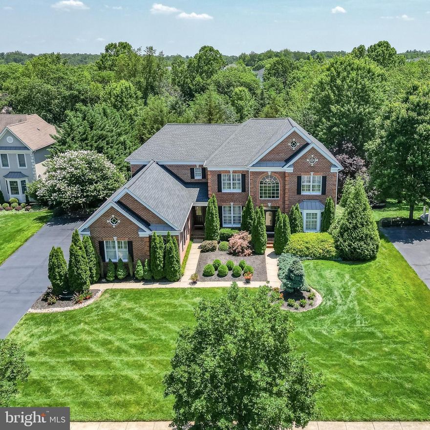 Stunning 6,700+ SQFT Chelsea Model in Award-Winning Dominion Valley Country Club. Welcome to this beautifully maintained executive home, perfectly situated on a large, private cul-de-sac lot—just a short walk from Battlefield High School and the community swimming pool. Located in one of Northern Virginia’s most sought-after neighborhoods, this stately residence offers space, elegance, and unmatched privacy.

This 5-bedroom, 6-bathroom home features a grand two-story foyer, curved staircase, and rare secondary front entrance. The spacious primary suite includes a sitting area and a luxurious en-suite bath. All additional upstairs bedrooms also feature private en-suite bathrooms.

The spectacular updated, light-filled gourmet kitchen is a chef’s dream with granite countertops, custom cabinetry, a large center island, wine refrigerator, gas cooktop, and an adjacent sun-drenched solarium. The main level is rich with custom details—gleaming hardwood and porcelain tile floors, elegant molding, plantation shutters, and two fireplaces (in both the family and dining rooms).

The main level also includes a handsome, private office with custom built-ins, a sunken family room with a floor-to-ceiling stone fireplace, formal living and dining rooms, and an expansive two-tier custom  Trex deck. Both grand and rear staircases offer easy access throughout the home.

The finished walk-out lower level is built for entertaining—featuring a large open recreation space, custom wet bar with granite counters and wine fridge, guest bedroom with full bath, media room (equipment conveys), gym/optional 6th bedroom (equipment conveys), and generous storage space including a full-size refrigerator.

Exterior highlights include a three-car garage, extended 8-car driveway, in-ground irrigation and lighting, and pristine landscaping on an almost ½ acre lot backing to a scenic pond and large rear easement for ultimate privacy.

Priced to sell at just $208/SQFT – well below recent comps!