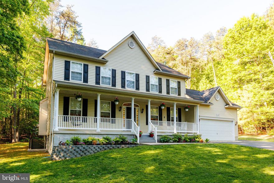 Set against a backdrop of 3.29 acres of mature trees and local wildlife, this beautiful three-level colonial offers an ideal balance of space and privacy. The journey begins on the charming front porch, where there is ample room for rocking chairs to sit back and soak in the surrounding peace. Inside, the home features an open-concept floor plan centered around a beautifully updated kitchen. A true showstopper, the kitchen boasts elegant quartzite countertops, light custom cabinetry, a large central island perfect for stool seating, and a sunny breakfast nook for your morning coffee. This heart of the home flows directly into the cozy family room, with lots of  natural light and  a warm gas fireplace.
The main level also has a formal dining room designed for hosting and a private home office complete with custom built-in shelving. A conveniently located powder room is also found on this floor for guests. Just off the kitchen, a relaxing screened-in porch provides a front-row seat to the tranquil, treed landscape.

Upstairs, the primary suite features  a vaulted ceiling, a generous walk-in closet, and a connecting en suite bath with a soaking tub, separate shower, and double vanity. Every corner of this home is dressed to impress with fresh designer paint, new carpeting in the family room, and low-maintenance decking that makes outdoor living effortless. The property is completed by a two-car garage and a spacious unfinished basement with rough-in plumbing, ready for your personal touch. This home offers a rare connection to nature, backing directly onto 545 acres of conversed forest.  Whether you are exploring private pathways through the woods or taking a leisurely stroll to the nearby sandy beach, this home offers it all!