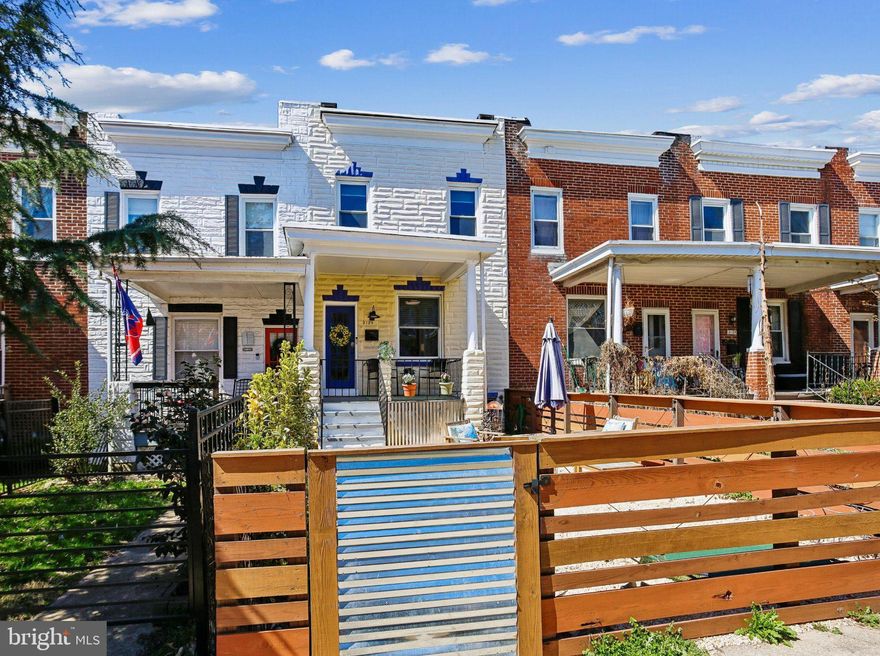 Welcome to 3124 Chestnut Ave. Nestled on one of the coziest yet vibrant blocks in 21211, this home is perfectly located just moments away from all that Hampden has to offer! This quintessential Baltimore  rowhome is welcoming and cozy, with a balance of classic features with practical updates, like Central A/C. The front and rear outdoor spaces currently provide a desirable combination: a parking pad in the rear and a fully-fenced low-maintenance (pea gravel) patio with a large covered (and gated) porch in the front. This space will be perfect to entertain, relax or get to know your neighbors!
The main level features timeless inlaid hardwood floors in the Living and Dining Rooms.  The Dining room leads to bright and spacious kitchen with white cabinetry. Off the kitchen you can access the back of the of the home and the parking pad.  On the upper level the home features 2 large light-filled bedrooms and 1 full bathroom. The much-improved lower level has very tall ceilings (approx 9ft), laundry and plenty of storage space. The home has been well cared for by it's current and previous owners. Fresh paint on the main and upper levels, front and back porch provide the new owners a blank canvas to make their own! All appliances and major systems are in good working condition and have either been replaced and/or had regular maintenance over the years.