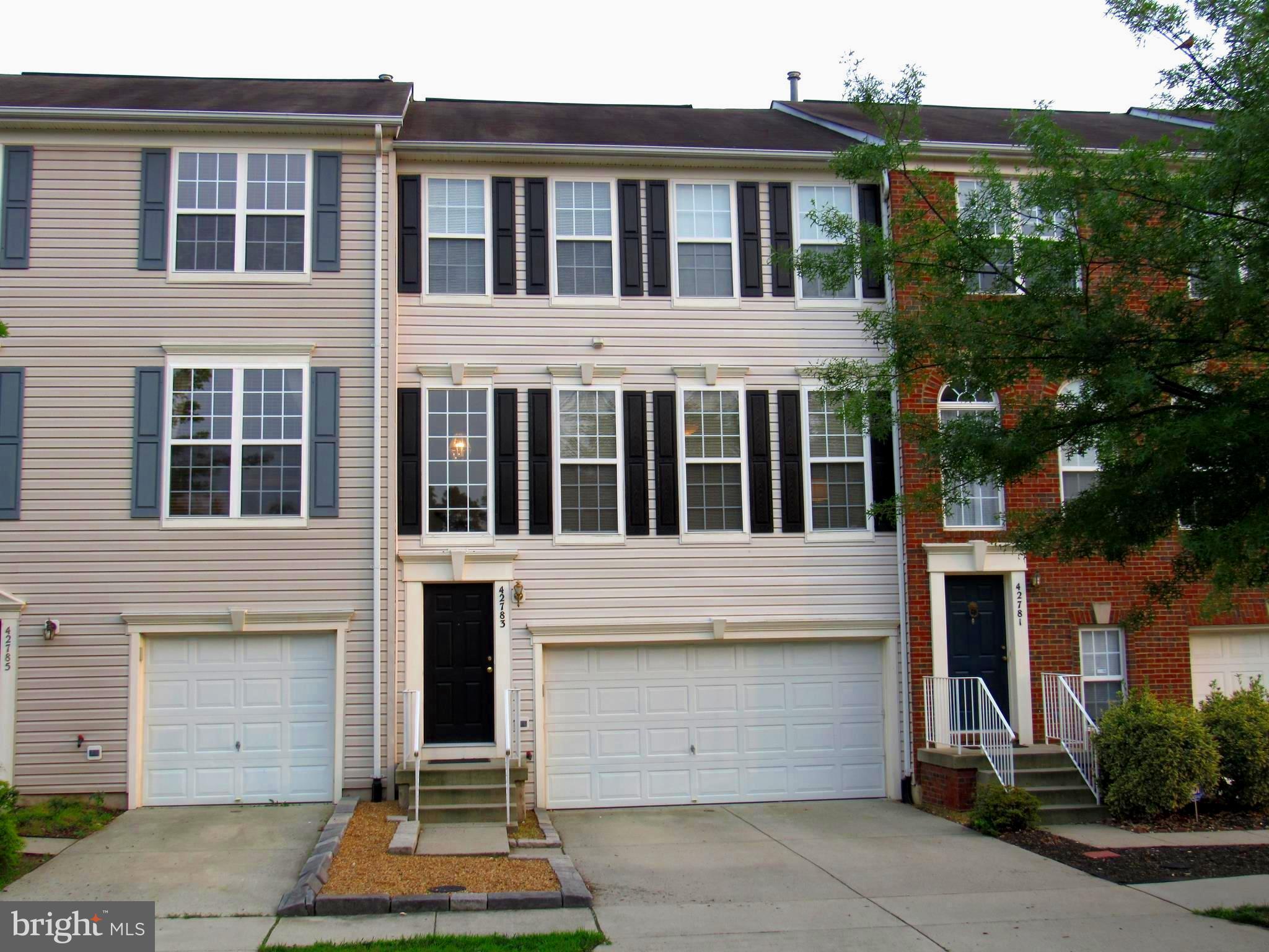 Spacious TH with hardwood floors on main level, ceramic tile in all bathrooms! Big kitchen with granite counters, center island, recessed lights, pantry, gas cooking, and many new appliances! All three bedrooms upstairs boast vaulted ceilings and ceiling fans. Primary bedroom has a walk-in closet and primary bathroom with two sinks. Fully finished lower level has recreation room, 3rd full bath, laundry (Maytag washer and dryer), and level walk-out to fully fenced rear with easy maintenance gravel rock. Huge no-maintenance deck offers relaxing view, backs to trees and single-family homes! New A/C condenser in rear yard (April 2025), new dishwasher (2024), new side-by-side stainless refrigerator (2023), new washer (2018), new HVAC air handling unit (2017), new water heater (2015)! Rear deck just power washed and garage floor painted - August 2025. Great location, walk to elementary school, tot lot, swimming pool, soccer fields, and tennis courts!