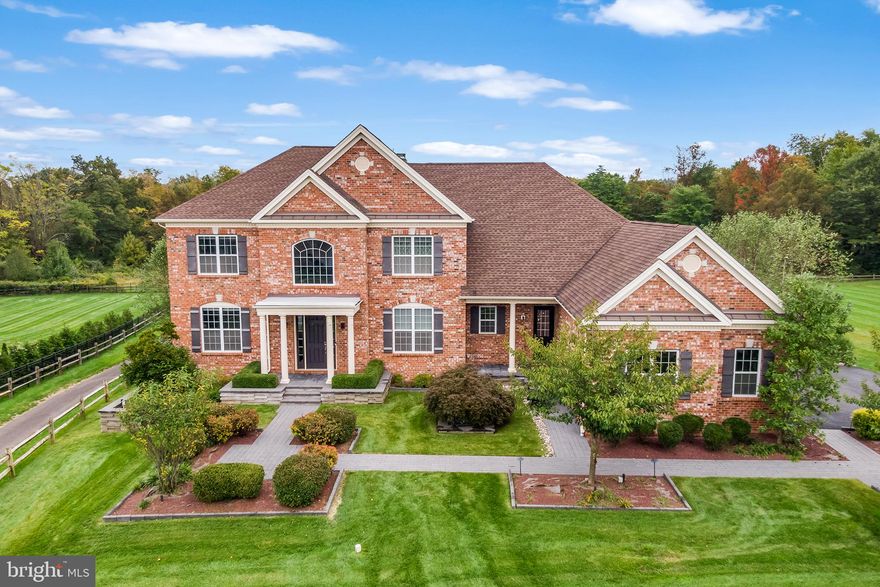 This stunning estate style home in the highly desired Estates of Mill Creek Ridge community within the award winning Central Bucks School District is looking for new owners. With over 7,000 square feet of living space, this immaculately maintained home truly has it all. Situated on nearly an acre, this home features a show stopping outdoor space with a 20x40 heated saltwater swimming pool with a motorized cover as the focal point and plenty of both indoor and outdoor space for entertaining. You’ll traverse the front walkway to approach the front door to which a soaring foyer with a curved staircase and hardwood throughout the main level welcomes you. A formal living room is to the left and your expansive formal dining room is to the right. Continuing forward is the beautiful great room with large windows and a gas fireplace. Off the great room is a flex room with huge windows perfect for a home office or playroom, as well as a first floor bedroom, and a full hall bathroom. Opening to the great room is the large eat-in kitchen where you’ll find cabinets galore with a professional level JennAir gas cooktop, a wall range and microwave, an oversized island with seating, and all stainless steel appliances. The sunroom with three skylights provides a view of the peaceful backyard and access to the oversized partially covered and heated rear deck. You’ll also find the laundry room, mudroom, and access to the oversized three-car garage with a Tesla charger and second staircase off the kitchen. The second level has three secondary bedrooms all with their own ensuite bathrooms, ample closet space, and large bright windows. The primary suite oasis is huge and has views of the backyard and three walk-in closets. The stunning dressing room closet has an island and custom built-ins and provides access to the spa-like ensuite bathroom. With an upgraded his-and-hers concept you have two different vanities and water closets with their own entrances. The jetted soaking tub and glass-enclosed shower is in the middle to separate the space. Descending to the full finished walkout basement, you’ll find even more functional living space. A large recreation room in the center with an electric fireplace not only has a full wet bar with a drink cooler but also another kitchen area with a full fridge, another sink and even a dishwasher. A movie theater with tiered seating and surround sound, will make everyone want to curl up for a movie. There are three additional rooms that can be used for anything from a home gym, guest bedroom, another home office, or hobby room; literally the possibilities are endless! This entire level is served by the sixth full bathroom. This space leads out to the custom covered back patio, custom firepit and hot tub where you can enjoy all the wonderful trees the property has to offer including Sweet Bay Magnolia, Cherry Blossom, Japanese Maple and Birch. There are even pine trees in the back for privacy. The entire home is served by a full home Generac generator, whole home water filter and softener, 400 amp electricity, 75 gallon hot water heater, six hard wired Ring security cameras, motorized Serena Shades controlled by a smart phone, entire yard Wi-Fi controlled sprinkler system, electrical outlets with timers, Casetta smart switches, and motion sensor lights in the bathrooms and closets. A private community walking/jogging path over 2 miles long is an added bonus. Robin Run Lake for fishing and boating is also just a short distance away. With its convenient location close to local golf clubs, wineries, dining, shopping, and quick access to many quaint towns such as Newtown, Doylestown and New Hope, you won’t want to miss this one!