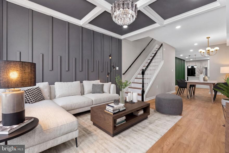 Welcome to 1134 N Fulton Ave, a breathtaking total renovation that redefines urban luxury. This expansive 5-bedroom, 3.5-bathroom townhouse combines bold architectural statements with high-end finishes, offering nearly incomparable style and space in the heart of Baltimore.
Step inside to an light-filled floor plan featuring wide-plank flooring and soaring ceilings. The living area is a true showstopper, centered around a geometric tray ceiling with recessed lighting and a stunning crystal chandelier. A custom charcoal-gray slat accent wall adds a layer of modern texture that sets this home apart from the rest.
The flow continues into a dedicated dining area and a chef’s kitchen designed for both function and flair. Crisp white Shaker-style cabinets accented with brushed gold hardware. Sleek white quartz countertops and a classic subway tile backsplash. Full stainless steel suite including a slide-in range and French door refrigerator. A striking deep-green vertical slat feature wall provides a vibrant pop of color and architectural interest. The upper floors house spacious, sun-drenched bedrooms with high ceilings. The primary suite is a true retreat, featuring ample closet space and a spa-inspired ensuite bathroom with floor-to-ceiling custom tile work and contemporary matte black fixtures. Each additional bathroom is finished with the same level of care, featuring designer vanities and artistic tiling.
The fully finished lower level provides the ultimate flex space—perfect for a family room, home gym, or media center. It includes additional bedrooms and a full bath, making it an ideal setup for guests or a multi-generational living arrangement. A classic Baltimore facade with a fresh, modern palette and updated windows.
All-new mechanical systems, plumbing, and electric ensure worry-free living for years to come. Conveniently located near local parks, transit, and just minutes from the revitalization of West Baltimore.
 Schedule your private tour today and experience the pinnacle of Baltimore city living!