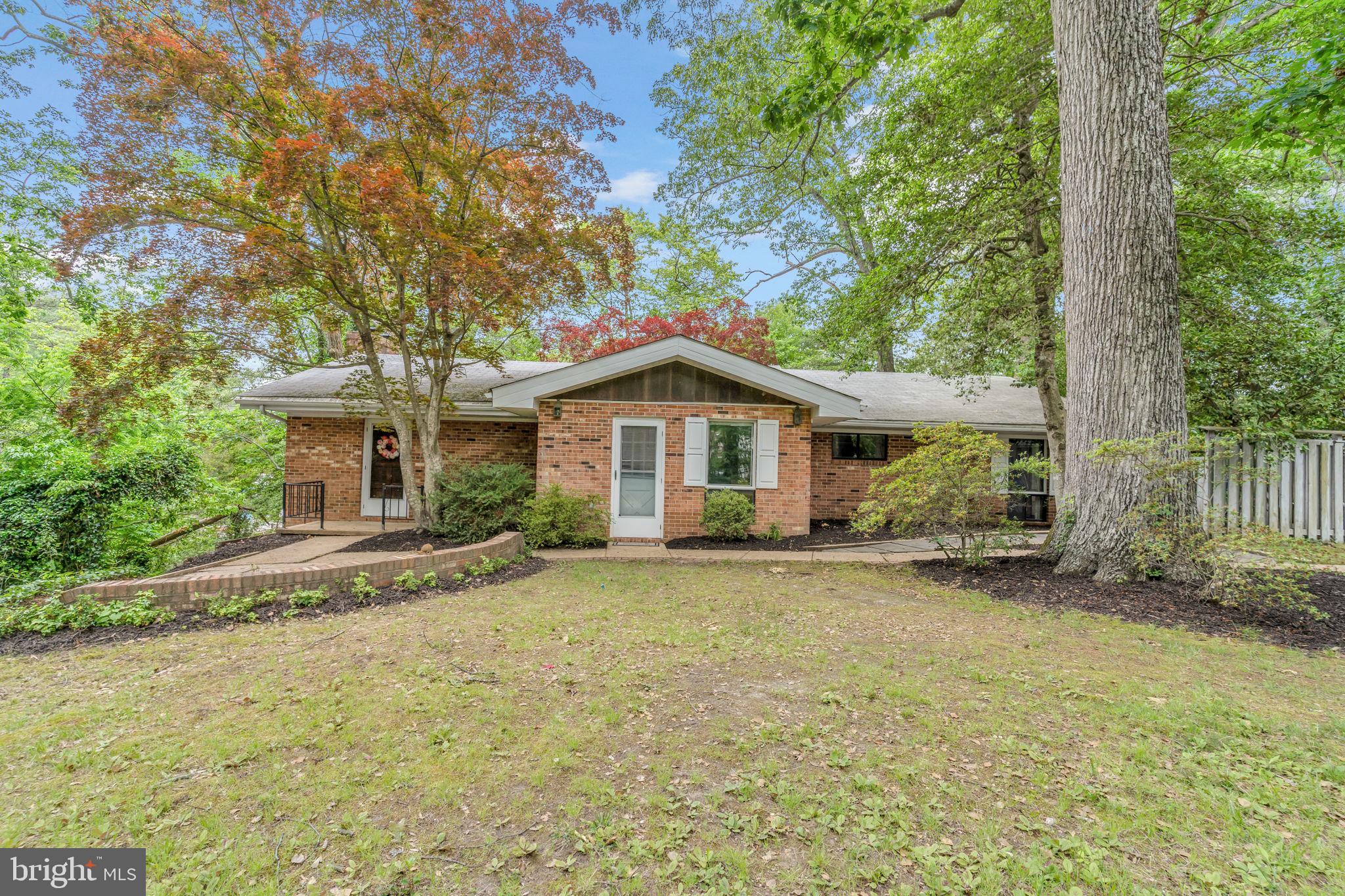 Location, Location, Location!!! Waterfront, navigable deep water with riparian rights and beautiful views from your new backyard deck. This rambler sits on a hill over looking St. Inigoes Creek surrounded by mature shrubberies, beautiful hardscaping and trees which offers lots of privacy. The grand and spacious living area greets you with a vaulted beautiful cedar plank ceiling with wood beams, wood flooring, a built-in bookcase and plenty of open space to have separate dining and living room areas. Cozy up by the brick mantle wood burning fire place while enjoying spending time with friends and family, sitting alone listening to your favorite tunes, reading a book or doing whatever make you happy. There is a primary bedroom with a primary bathroom and two other bedrooms with a full hallway bath. There is a walk out basement to easily access a path that leads you to the water. The water is deep enough to dock a sailboat (pier is in disrepair). This house is ideal for those who own a boat, who enjoy water activities or simply enjoy the calm serenity of relaxing by the water. This house is ready for it's new owner. Come take a tour!!