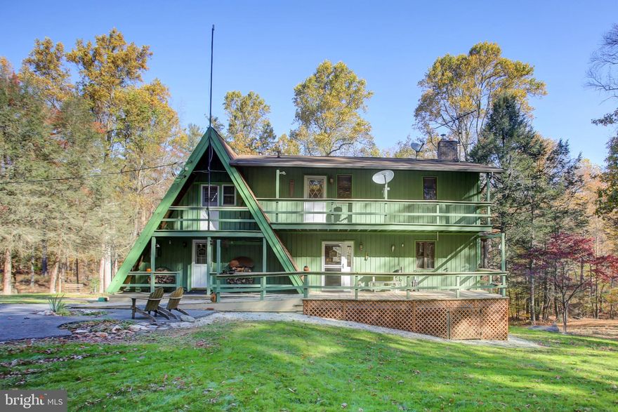 *Offer Deadline is Sunday Night*Looking to get away from it all? Nestled on a serene, private 6.4 acre end lot with wooded views and abundant wildlife, this charming A-frame original home with a large, thoughtful addition is the perfect retreat from the hustle and bustle of daily life. The home features two traditional bedrooms and three full baths, with plenty of extra space to easily add more sleeping areas, making it ideal for growing families or hosting guests. As you step inside, you’ll be greeted by the cozy yet spacious layout. The expansive kitchen is a chef’s dream, boasting newer LG appliances, an oversized island perfect for entertaining, and ample counter and cabinet space. Just off the kitchen, the dining area flows seamlessly out onto the large deck where you can take in the peaceful, quiet surroundings and watch the many deer and turkey who frequently visit. The original living room boasts wood beams, a gorgeous view outside the large windows and is anchored by a stunning floor-to-ceiling brick wood burning fireplace that draws the eye up to the loft balcony. The loft in the A-frame section provides an ideal space for a home office, reading nook, or additional sleeping area, and overlooks the living room and its striking floor to ceiling brick wood burning fireplace and vacation-style views of the deck and woods beyond. The original smaller kitchen off the living room would make a convenient wet bar, snack and pantry over-flow.
The lower level of this home offers incredible versatility, perfect for use as a spacious rec room or additional living space. With its open layout and large windows that let in plenty of natural light, the area provides endless possibilities for a home theater, game room, or even a guest suite. Heat sources throughout the home include two newer mini-split heat pumps on the main level, three cozy woodstoves, and a newer oil furnace, ensuring comfort and warmth all year long. A Speed Queen washer dryer set is included on the main level. For peace of mind, the home has a radon mitigation system installed and is wired for a generator. The seller has removed some of the old carpeting in several rooms, making it easier for the next owner to install new flooring of their choice for a blank slate to personalize the space to suit your style and needs, and the property is priced below market value to give you a built-in flooring allowance. In addition to the main home, the property includes an oversized two-car garage, and a convenient tractor shed, offering plenty of storage for vehicles, tools, and equipment.
Whether you're looking for a weekend getaway or a full-time residence, this home delivers the ultimate "retreat away from it all" experience. With its spacious layout, peaceful setting, and rustic charm, it offers a rare opportunity to own your own slice of paradise. The beginning 2.6 acres is made up of two lots that are half cleared, half wooded with a stream was previously perc’d and surveyed for another residence and could be possible to build on, Buyer to verify with the township and sewage enforcement officer for details.