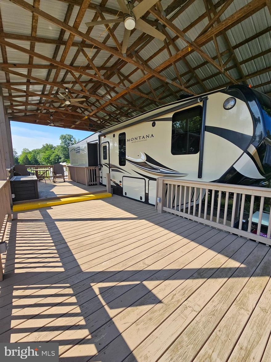 Welcome to your home away from home in Riverbends seasonal campground open April 1 - November 1 each year. 
Block 21 Lot 15 on Old Faceful St and is a welcoming lot not far from to all the amenities that Riverbend has to offer. On Sewer, huge plus. It has the perfect spot to sit and watch the incredible Firework show without leaving your porch. A 2017 MINT condition NEVER been exposed to the weather elements 34' 3" Montana High Country 5th wheel #HM305RL sits under a large 40 * 25 stick-built pavilion with a beautiful double deck for hosting or relaxing, also featuring many outlets all around, and 3 ceiling fans with remotes. This 5th wheel sits on a concrete pad with one parking spot. Inside is in immaculate condition with a sofa bed (never used) leather sofas, fireplace, built in wine rack, large refrigerator, kitchen island, washer and dryer in the king-sized bedroom, with its own separate A/c unit and so much more. You MUST see to really appreciate.  This lot satisfies all your camping needs with minimal maintenance. Want to leave for the winter? Sure thing, this spot is perfect to pack up and take it south with ease. 1997 Golf cart also conveys. It runs but it needs a battery. 

Approx. 10 miles of Deep water on the Potomac River access for boating, fishing & swimming. Yearly membership ($1,775) plus a $200 initiation fee for new owners, includes water, this one is on sewer, pump outs, electric, trash and the park amenities such as 3 pools, putt putt course, Horseshoe club, Boat club, Poker runs, Trick or Treat, Christmas in July, live bands, basketball court, tennis court, fireworks, car show, Church, restaurant, bar, convenience store (Great food), playground, volleyball, ball field and much much more. Bring your golf carts, water toys and come enjoy life!