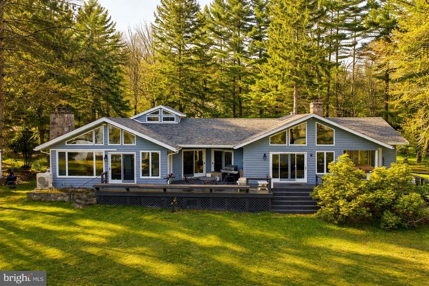 Experience lakeside living with this stunning contemporary retreat, perfectly situated on a level lot within the serene 1000 Acres community. Boasting an impressive 187 feet of lake frontage and a coveted Type A private dock, this home offers unparalleled access to the best of Deep Creek Lake. The heart of the home features a newly renovated kitchen equipped with stainless steel appliances and upgraded countertops, flowing seamlessly into an open-plan living area. This spacious residence includes 4 bedrooms and 3.5 bathrooms, providing ample room for family and guests. Enjoy the warmth of two wood-burning fireplaces—one in the main living area and another in the primary suite—perfect for chilly mountain evenings. Step out onto the expansive deck or soak in the hot tub while taking in breathtaking lake views. The level lot makes it easy to stroll down to the water’s edge. The sale includes an additional 2.69-acre parcel located just across the street, offering extra privacy and potential. Whether you're looking for a year-round residence or a premier vacation getaway, this property is designed for those who want to relax and enjoy the very best of waterfront life. This property is truly ready for its next chapter!
