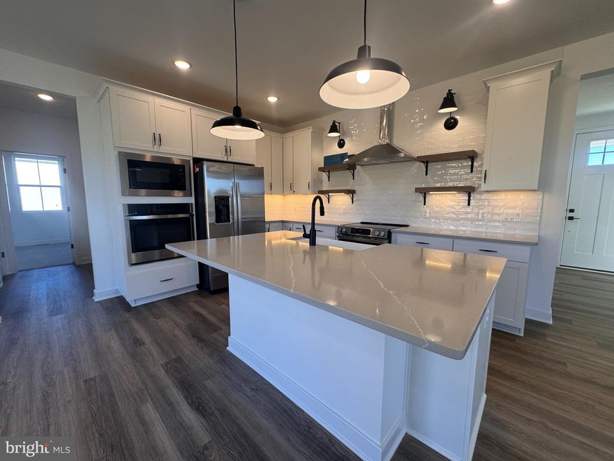 Why settle for a resale home when you can buy a BRAND-NEW HOME! This stunning is completed and move in ready! Welcome to Estates of Tuscarora, a brand-new community offering 1+ acre homesites within close proximity to commuter routes, shopping, parks, and Historic Downtown Martinsburg! The Baltic 2-story colonial home on 1.6 acres located on Homesite #19, includes a 2-car garage, 5-bedrooms, and 4 bathrooms. This home blends timeless Farmhouse interior design with modern convenience! Offering an open floor plan, this home is perfect for both comfortable living and entertaining. The inviting family room with gas fireplace is seamlessly connected to the kitchen and casual dining area. The well-appointed gourmet kitchen features soft close cabinets, GE Stainless Steel appliances with range, hood vent, built-in wall oven and microwave, complete with a spacious island with quartz countertops. This home includes a home office an extra bedroom and full bath on the main level, ideal for guests, in-laws, or a flexible living space! The upstairs includes a generous loft area, 3 secondary bedrooms, laundry room and spacious Primary Bedroom. The Primary Bedroom boasts a tray ceiling and luxury bath complete with a frameless shower door and free-standing soaking tub. The finished basement recreation room and full bath complete this home on a walk-up homesite. This home is a perfect blend of charm, functionality, and space, designed to meet all your needs. Don’t miss the opportunity to make this remarkable home your own! Call and schedule your personalized appointment today! Ask about our closing cost assistance with the use of K. Hovnanian American Mortgage **See Sales Consultant for more information**