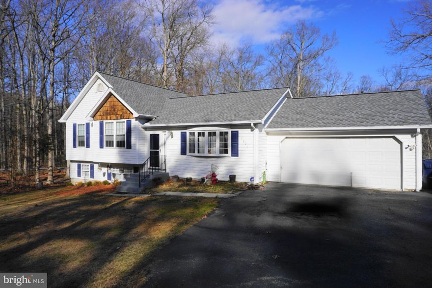 This move-in-ready home has been meticulously cared for, offering peace of mind with several key updates.  The living room is bright and neutral, featuring a large bay window.  A new roof was installed in 2023. The heating and cooling systems are newer. The windows have been replaced except for the living room window.  Enjoy a backyard view from the kitchen window when doing your dishes.  The large rear yard backs to a stream, offering a peaceful, nature-filled retreat right from the deck. The dining area has French doors to the deck. The main bedroom features a private bath with a full tub. Each bedroom has a ceiling fan. The basement has an unusually high ceiling (approx 15 ft).
Most of the basement is finished with laminate flooring and a pellet stove. It is a great place for your family room. There is a 20 x10 area open to an 11 x11 area, plenty of flexible space to use for entertainment or hobbies. The two-car garage has access to the rear yard. The driveway is a double-wide and can fit up to five cars. There are kennels and a shed in the backyard.