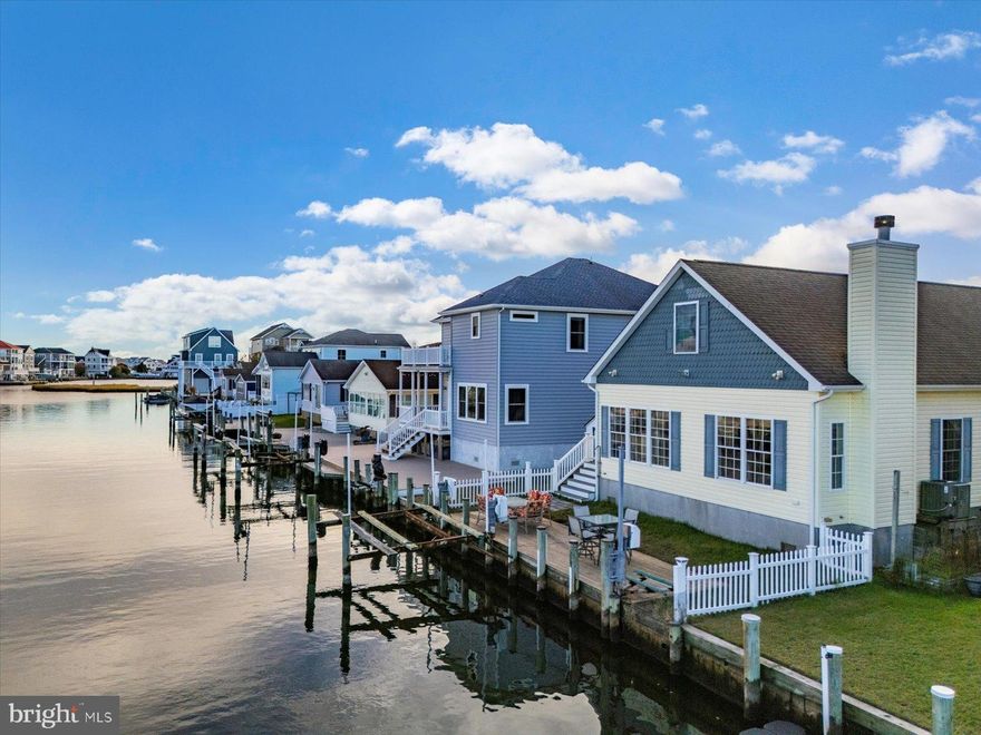 This is the only home on the market in Cape Windsor!  The most recent sale in the community was $1,625,000. This gem was just reduced to $879,900!!!  Don't wait to check out this charming, coastal, move-in-ready, waterfront home with a wide canal in the sought-after Cape Windsor community. The boating season is coming soon, but you still  have plenty of time to make this home your own. Cape Windsor does not allow weekly rentals, creating a quieter, more desirable setting for year-round residents or long-term tenants (rentals over 180 days are permitted)  This waterfront community is located less than two miles from the beaches of Fenwick Island and Ocean City.   Inside, you’ll find a bright, open floor plan with three generously sized bedrooms featuring new carpet, laminate flooring throughout the main living areas, and abundant natural light.  The sunroom is a true highlight, with a wall of windows, a wood-burning fireplace, and peaceful views of the canal and Route 54 Bridge—perfect for relaxing or entertaining. The kitchen is well-equipped with stainless steel appliances and a large island that comfortably seats four or more. The primary suite includes a spacious walk-in closet and a private ensuite bath with a stand-up shower finished in neutral ceramic tile. A convenient laundry room features a red stackable washer and dryer, utility sink, and an extra refrigerator.
Upstairs, a large bonus/recreation room with a propane stove provides flexible space for entertaining or relaxing, along with a half bath. In addition to the bonus room, there is a substantial attic storage area  that has the potential for additional living space. Step outside to experience true waterfront living. Enjoy your private dock complete with a boat lift and jet ski lift—ready for immediate use without waiting for permits. The fenced yard, outdoor shower, large storage shed, and detached one-car garage add both convenience and functionality. From your backyard, cruise directly into Assawoman Bay or simply unwind and take in the water views.
Cape Windsor offers outstanding community amenities, including an outdoor pool, boat ramp, community bayfront beach, and low-maintenance living. The HOA fee of just $2,000 per year includes water, trash, and snow removal. Whether you’re searching for a full-time residence, a weekend escape, or a long-term investment, this home truly checks all the boxes. Enjoy coastal living at its best—where the beach is minutes away and every day feels like a vacation.  What are you waiting for?