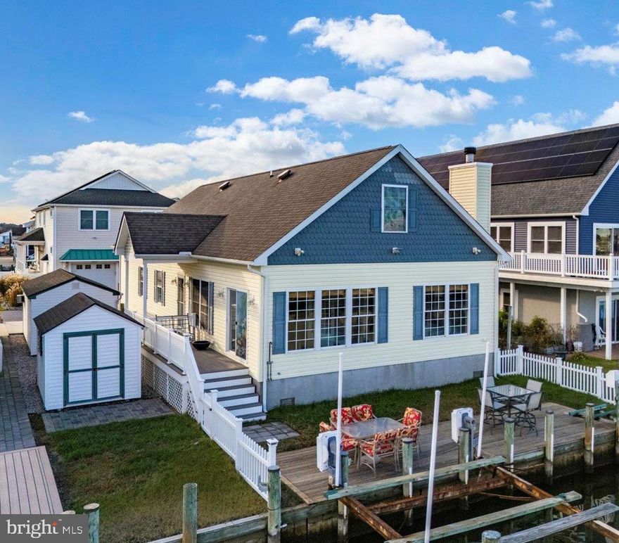 Don’t miss the opportunity to own this charming, coastal, move-in-ready, waterfront home in the sought-after Cape Windsor community. The boating season is coming soon, but you still  have plenty of time to make this home your own. Cape Windsor does not allow weekly rentals, creating a quieter, more desirable setting for year-round residents or long-term tenants (rentals over 180 days are permitted)  This waterfront community is located less than two miles from the beaches of Fenwick Island and Ocean City.   Inside, you’ll find a bright, open floor plan with three generously sized bedrooms featuring new carpet, laminate flooring throughout the main living areas, and abundant natural light.  The sunroom is a true highlight, with a wall of windows, a wood-burning fireplace, and peaceful views of the canal and Route 54 Bridge—perfect for relaxing or entertaining. The kitchen is well-equipped with stainless steel appliances and a large island that comfortably seats four or more. The primary suite includes a spacious walk-in closet and a private ensuite bath with a stand-up shower finished in neutral ceramic tile. A convenient laundry room features a red stackable washer and dryer, utility sink, and an extra refrigerator.
Upstairs, a large bonus/recreation room with a propane stove provides flexible space for entertaining or relaxing, along with a half bath. In addition to the bonus room, there is a substantial attic storage area  that has the potential for additional living space. Step outside to experience true waterfront living. Enjoy your private dock complete with a boat lift and jet ski lift—ready for immediate use without waiting for permits. The fenced yard, outdoor shower, large storage shed, and detached one-car garage add both convenience and functionality. From your backyard, cruise directly into Assawoman Bay or simply unwind and take in the water views.
Cape Windsor offers outstanding community amenities, including an outdoor pool, boat ramp, community bayfront beach, and low-maintenance living. The HOA fee of just $2,000 per year includes water, trash, and snow removal. Whether you’re searching for a full-time residence, a weekend escape, or a long-term investment, this home truly checks all the boxes. Enjoy coastal living at its best—where the beach is minutes away and every day feels like a vacation.  What are you waiting for?